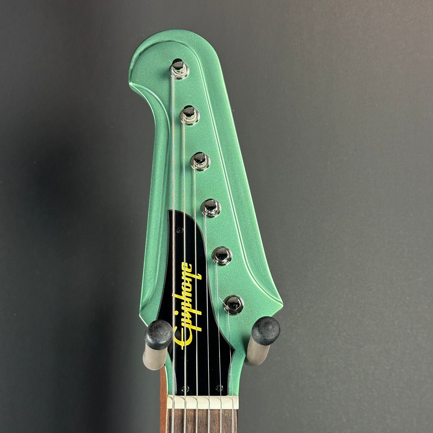 Front of headstock of Used Epiphone Inspired by Gibson Custom 1963 Firebird Inverness Green.