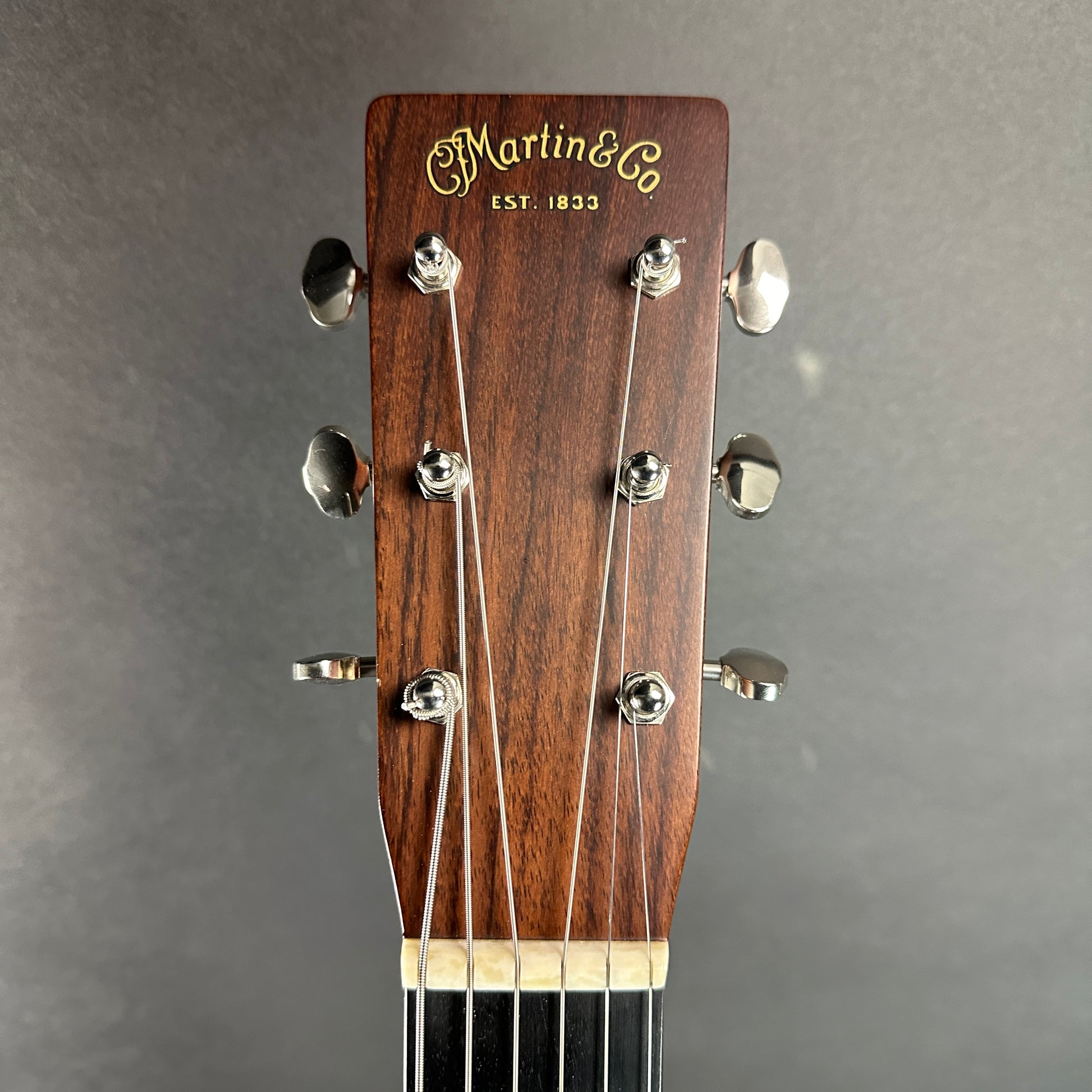 Front of headstock of Used Martin 00-28 Natural.