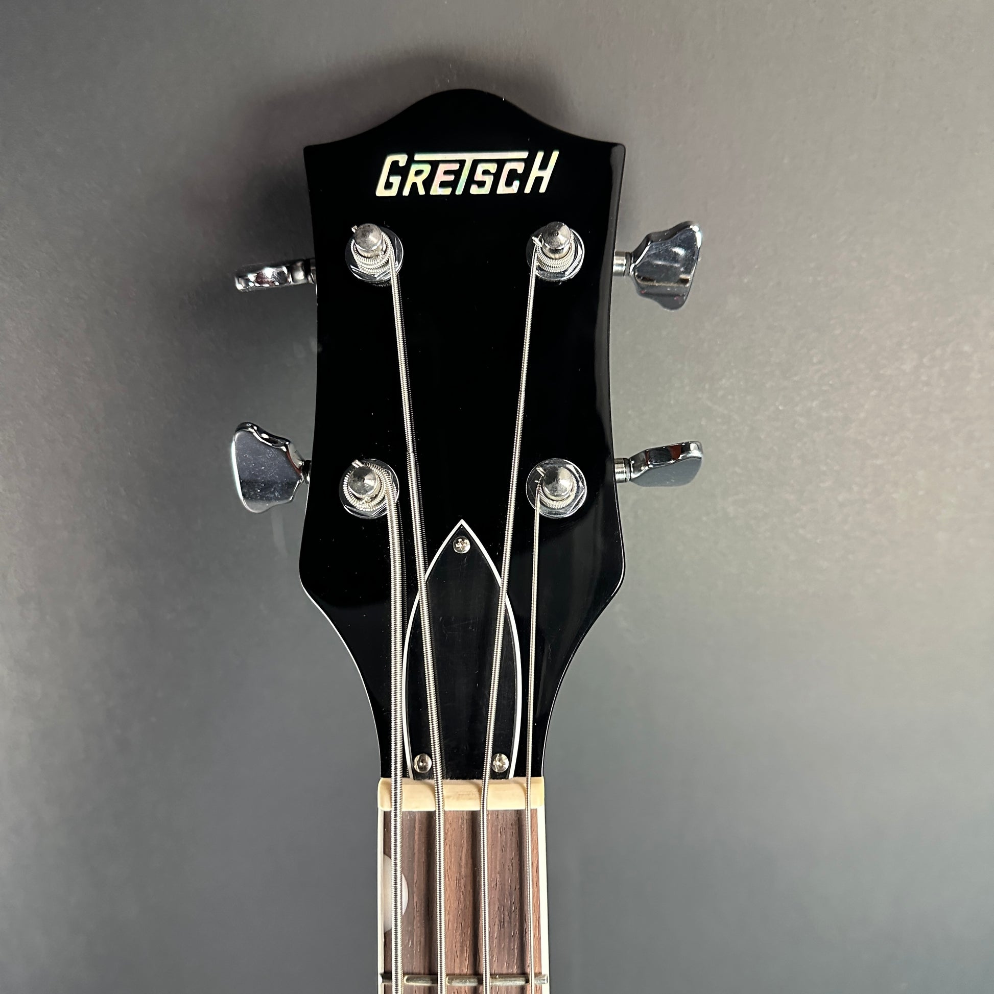 Front of headstock of Used Gretsch G6119B Walnut Broadcaster Bass.