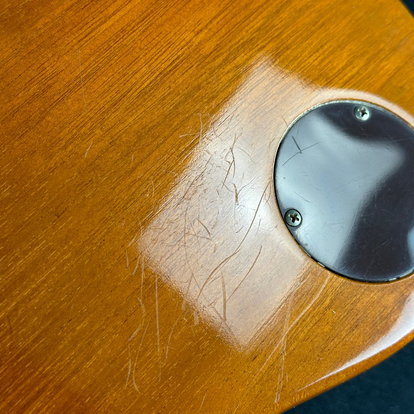 Scratches on back of body of Used Gibson Custom 1957 Les Paul Gold Top.