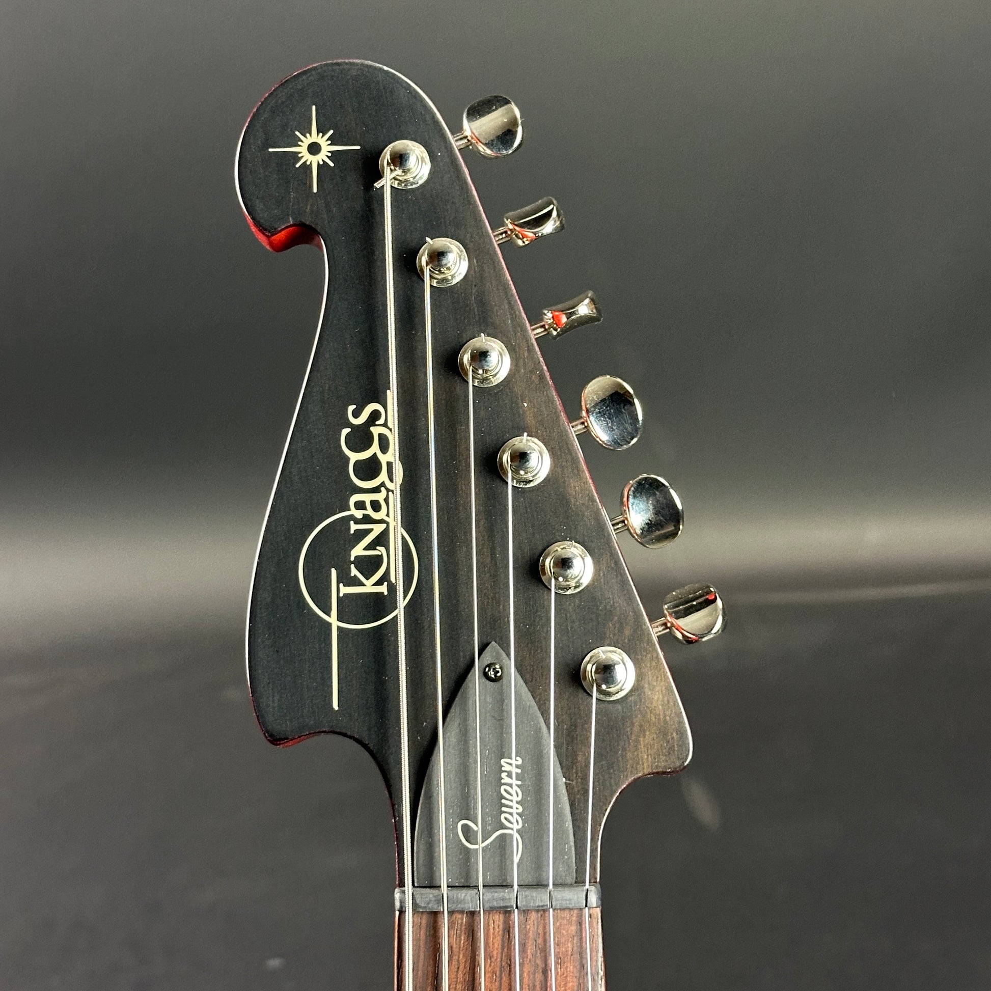 Front of headstock of Used Knaggs Severn HSS Cherry Sunburst.