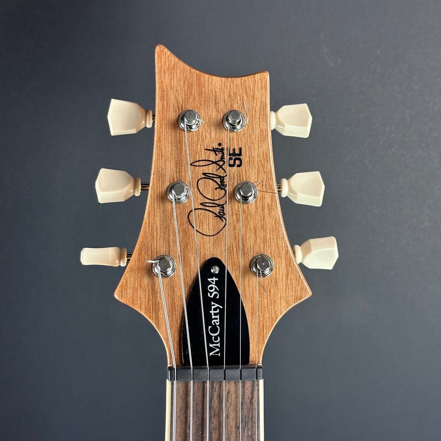 Front of headstock of Used PRS SE McCarty 594 Charcoal.