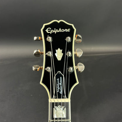 Front of headstock of Used Epiphone Nighthawk Custom Reissue.