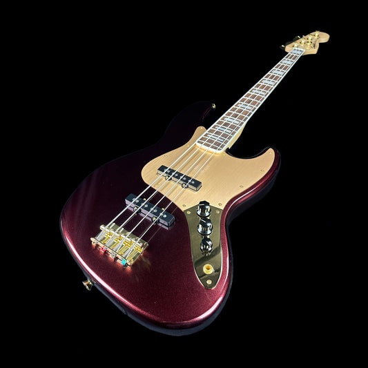 Front angle of Used Squier 40th Anniversary Jazz Bass Ruby Red Metallic.