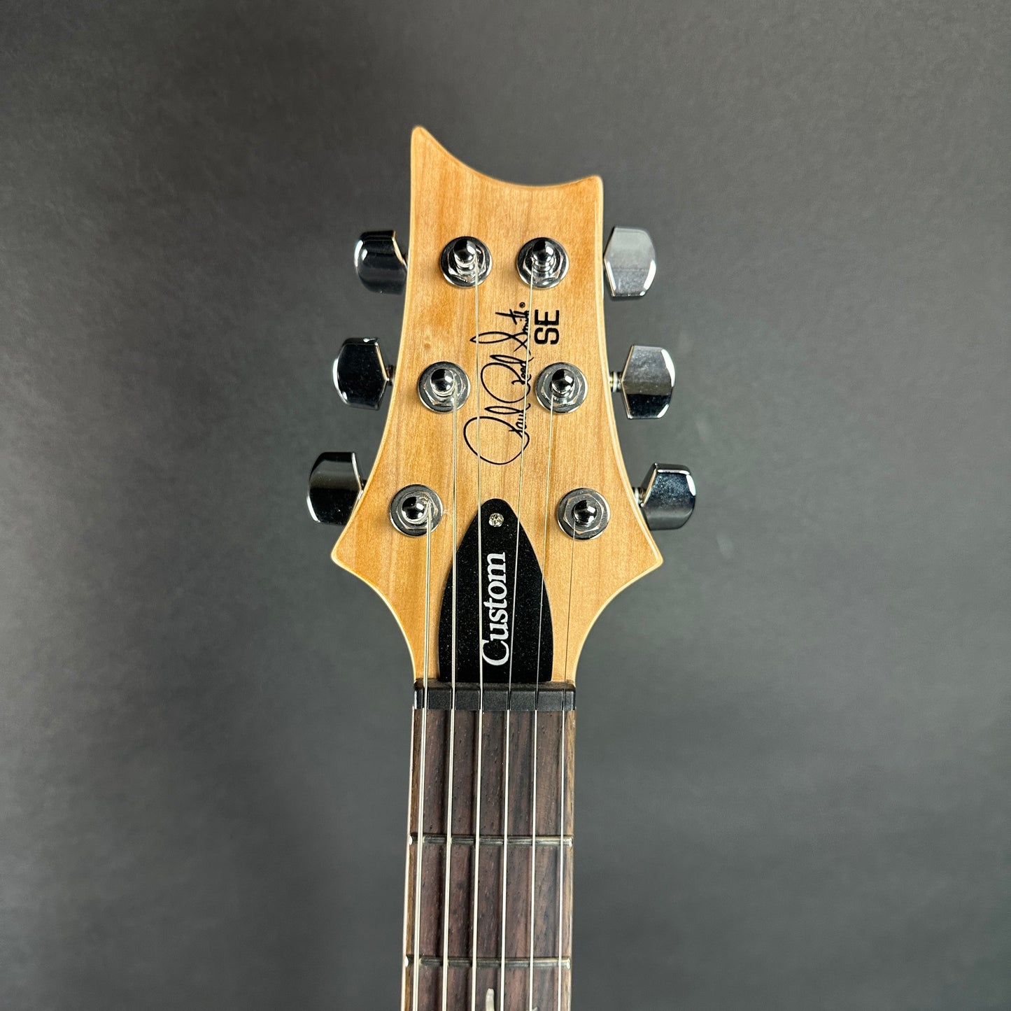 Front of headstock of Used PRS SE Custom 24 Bonnie Pink.