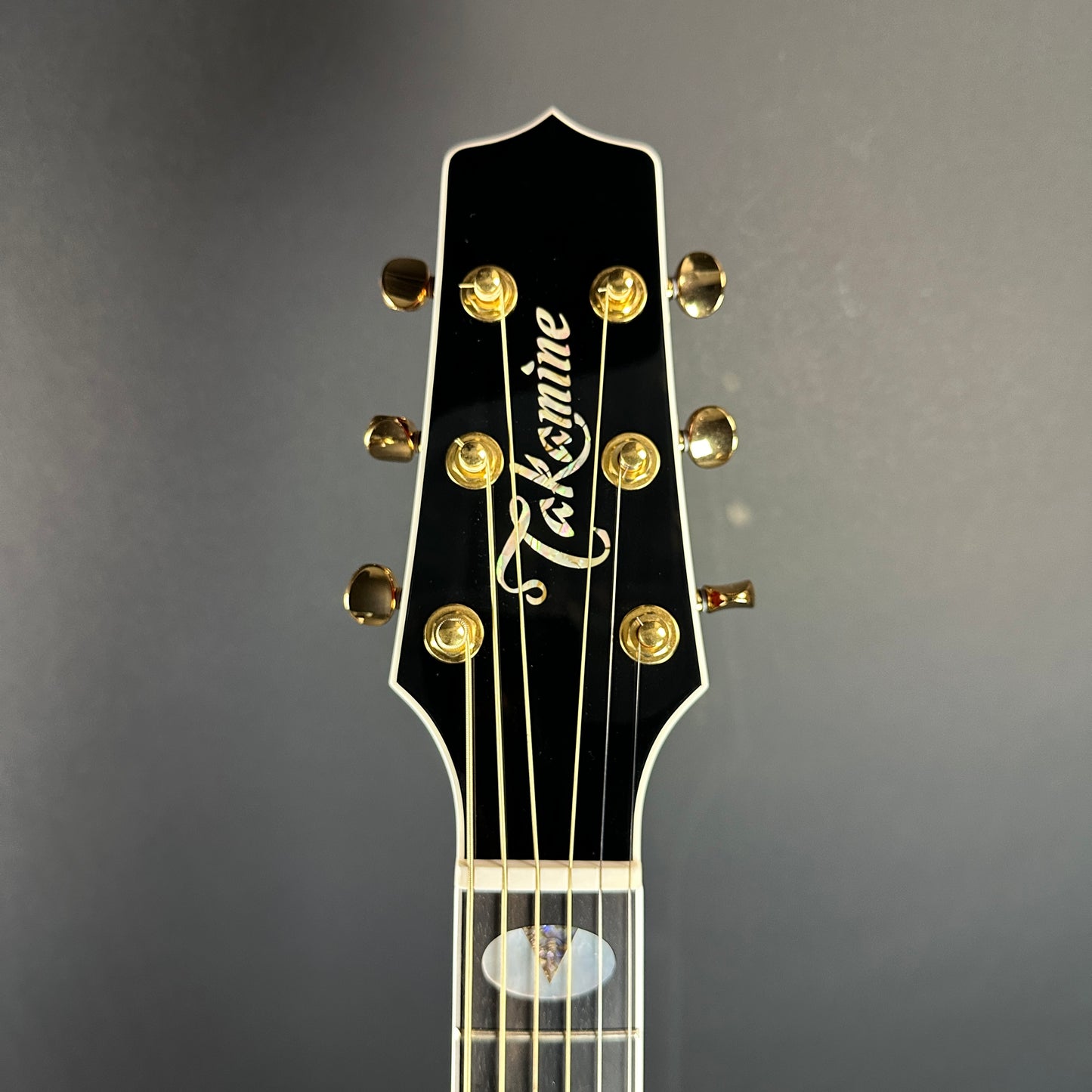 Front of headstock of Used Takamine TSP158C Red.