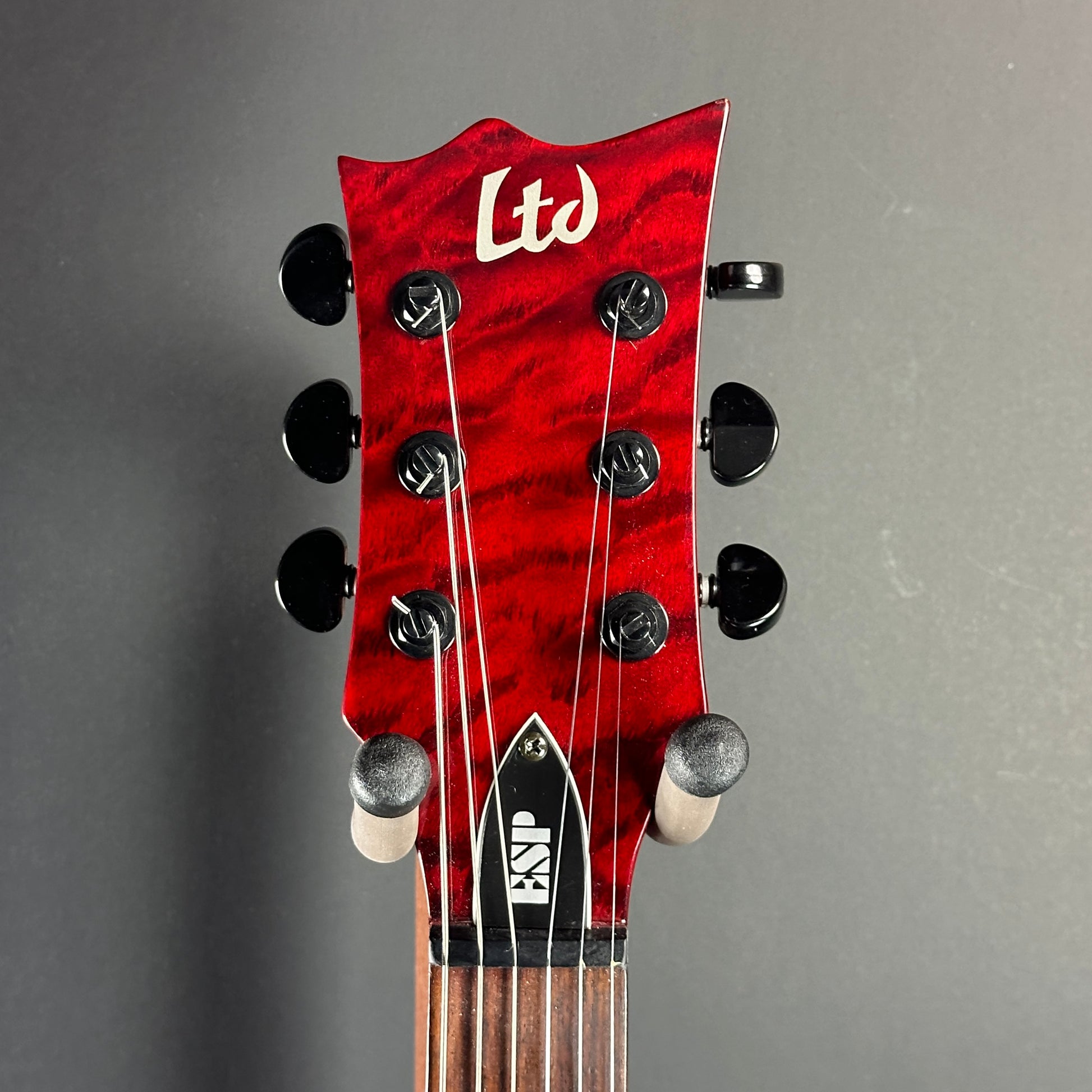 Front of headstock of Used LTD EC-100QM Fire Red.