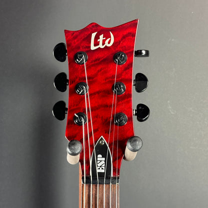 Front of headstock of Used LTD EC-100QM Fire Red.