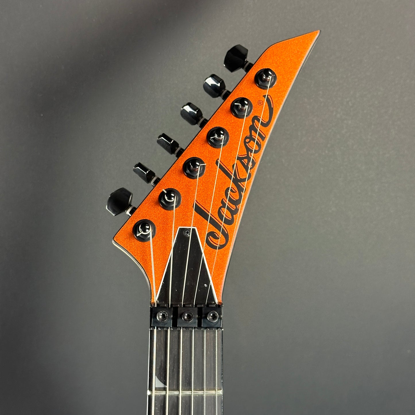 Front of headstock of Used Jackson Pro Series Soloist SL3 Satin Orange Blaze.