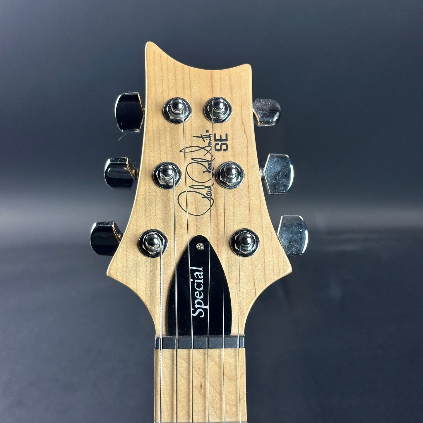 Front of headstock of Used PRS SE Special Charcoal.