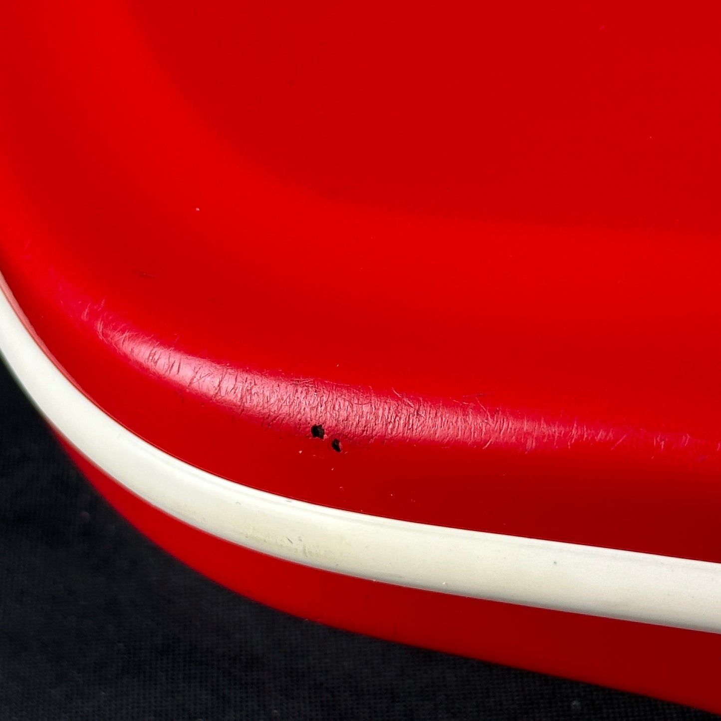 Damage on bottom edge of Vintage 60's Airline Red.