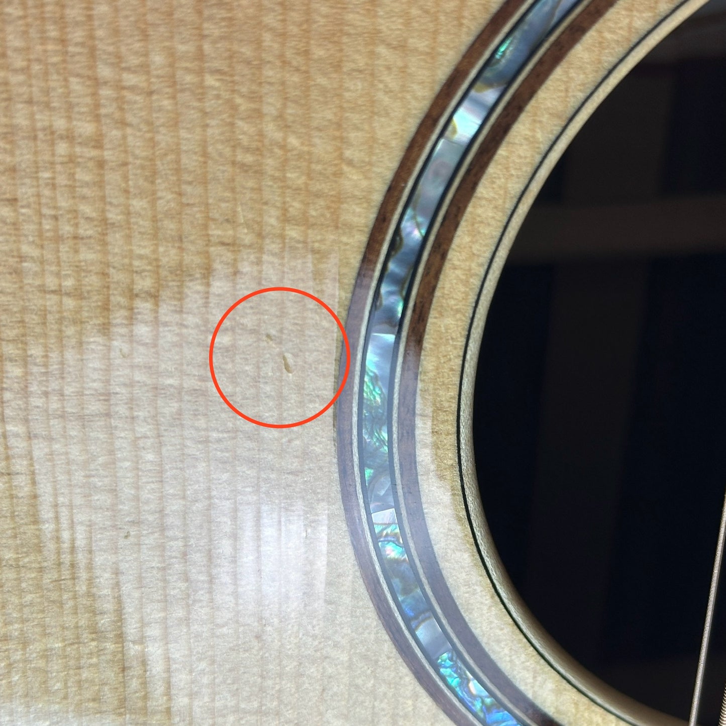 Small ding near soundhole of Used Taylor 856ce 12 String.