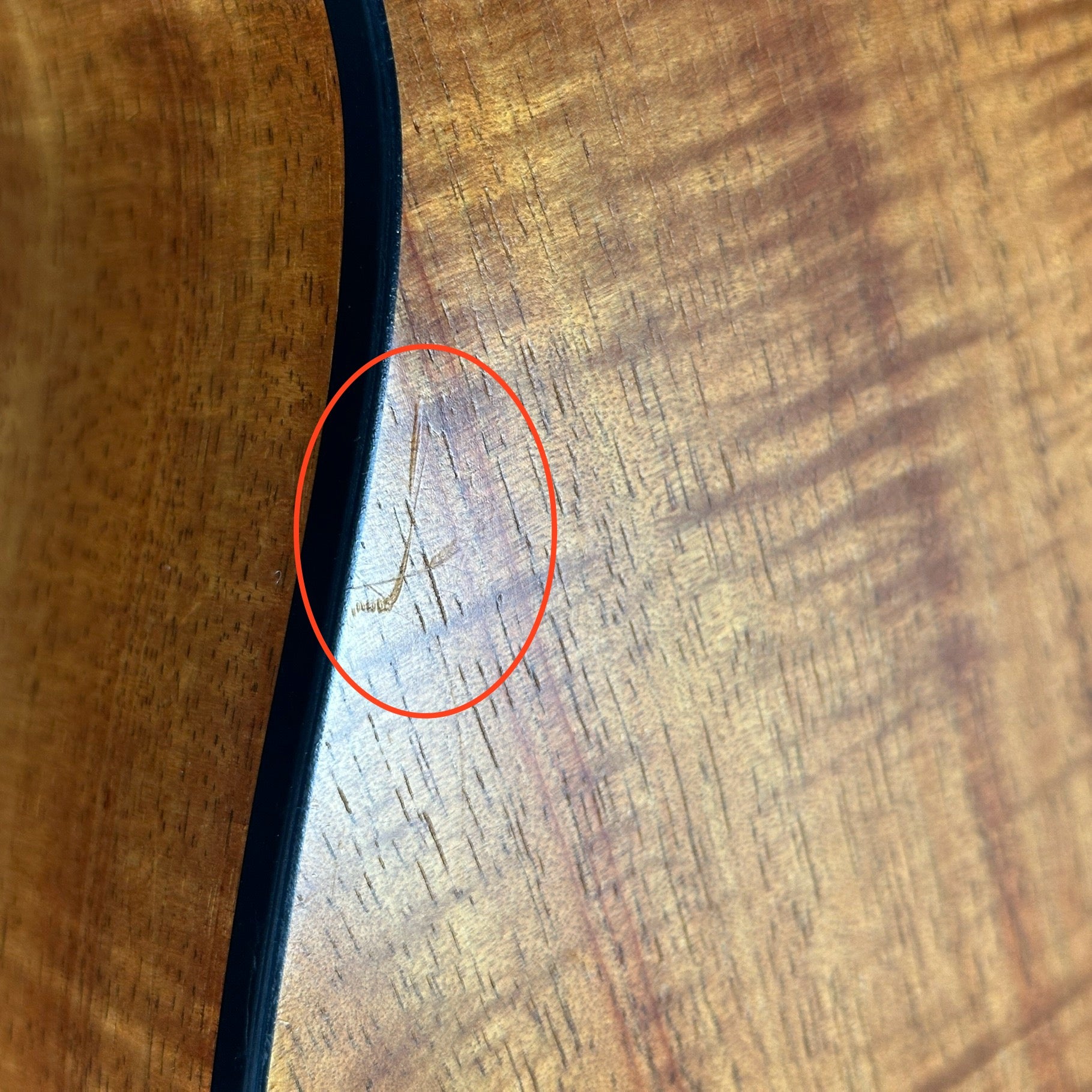 Scratch on back of Used Taylor 224ce-K DLX.