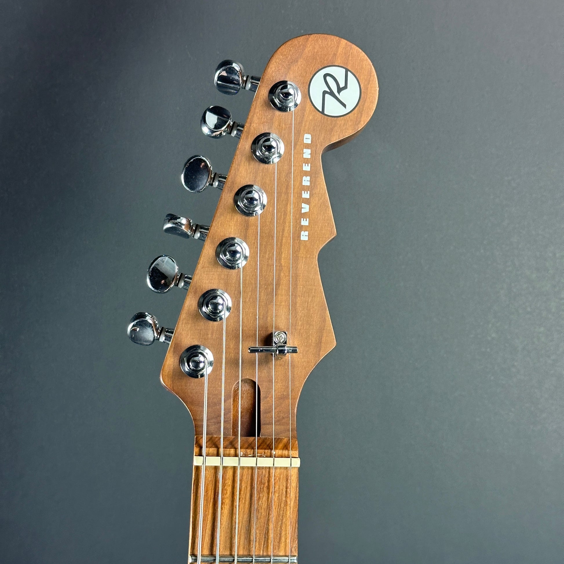 Front of headstock of Used Reverend Kingbolt RA Natural Flame Maple.