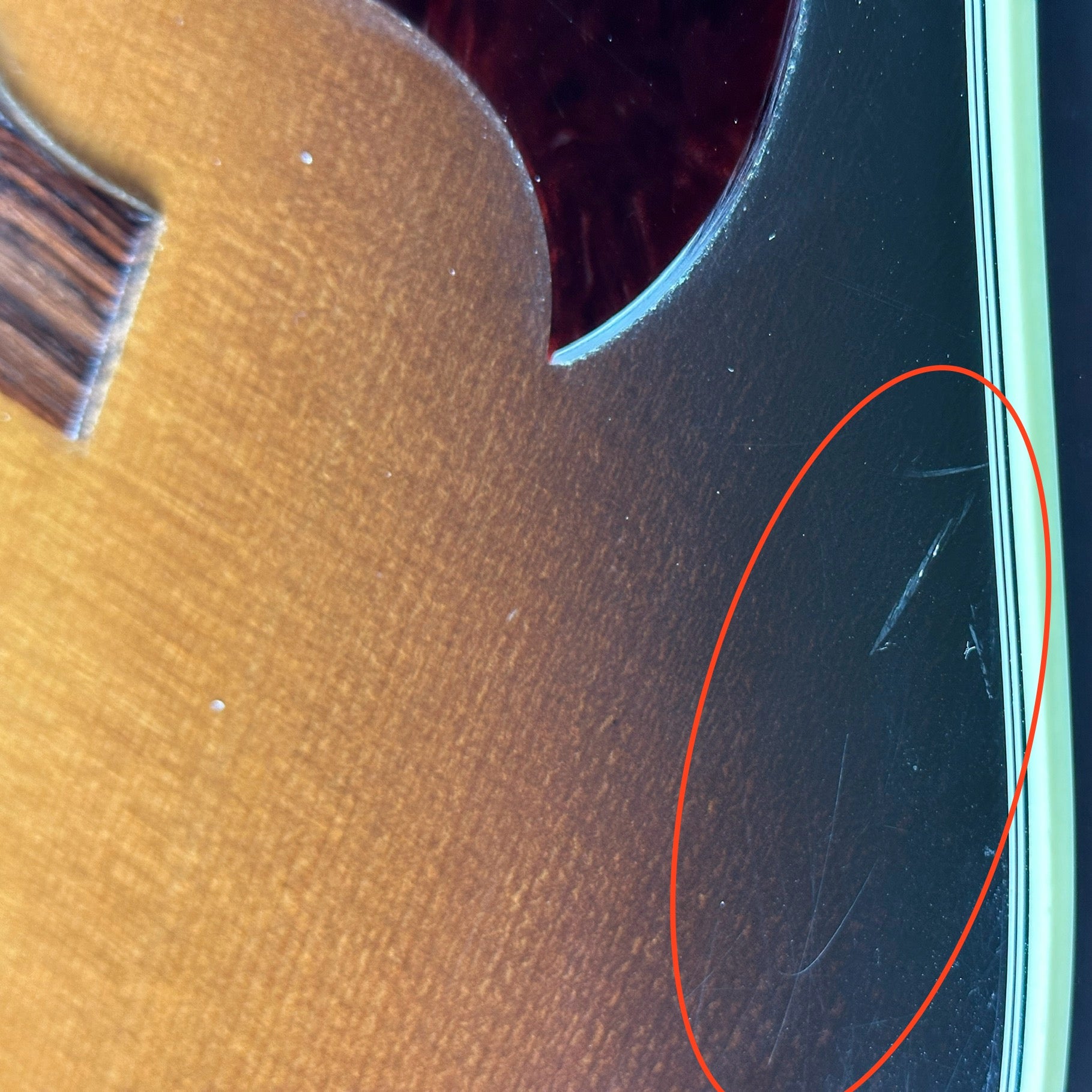 Scratches near pickguard of Used Gibson Hummingbird Pro.