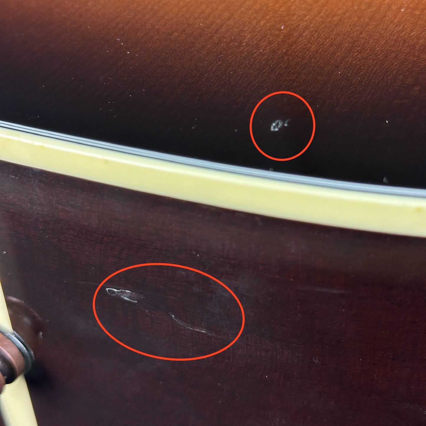 Damage near bottom strap button of Used Gibson Hummingbird Pro.