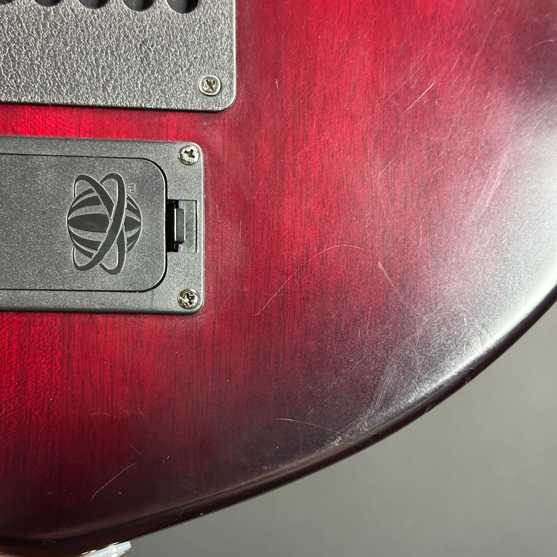 Scratches on back of Used Ernie Ball Petrucci Monarch Majesty Red.