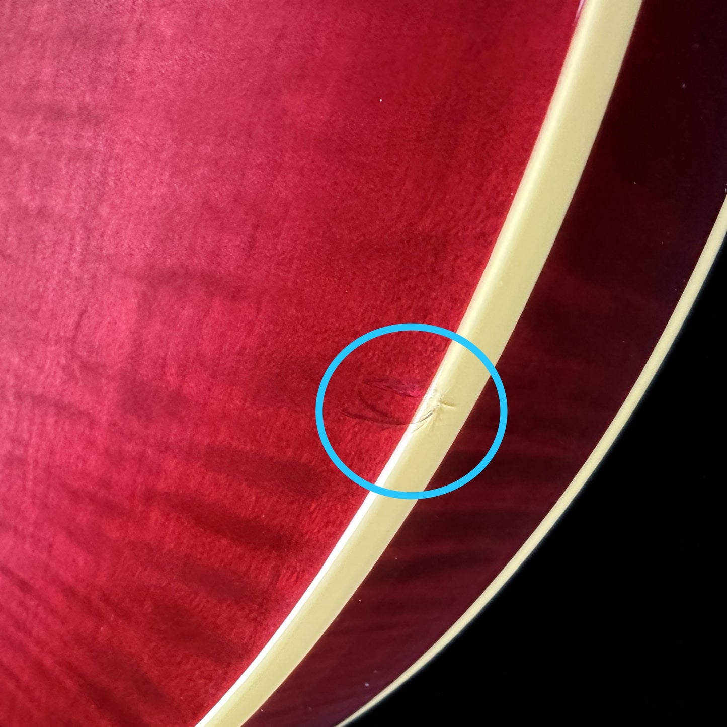 Dent on bottom edge of Used Epiphone ES-335 Figured Limited Raspberry Burst.