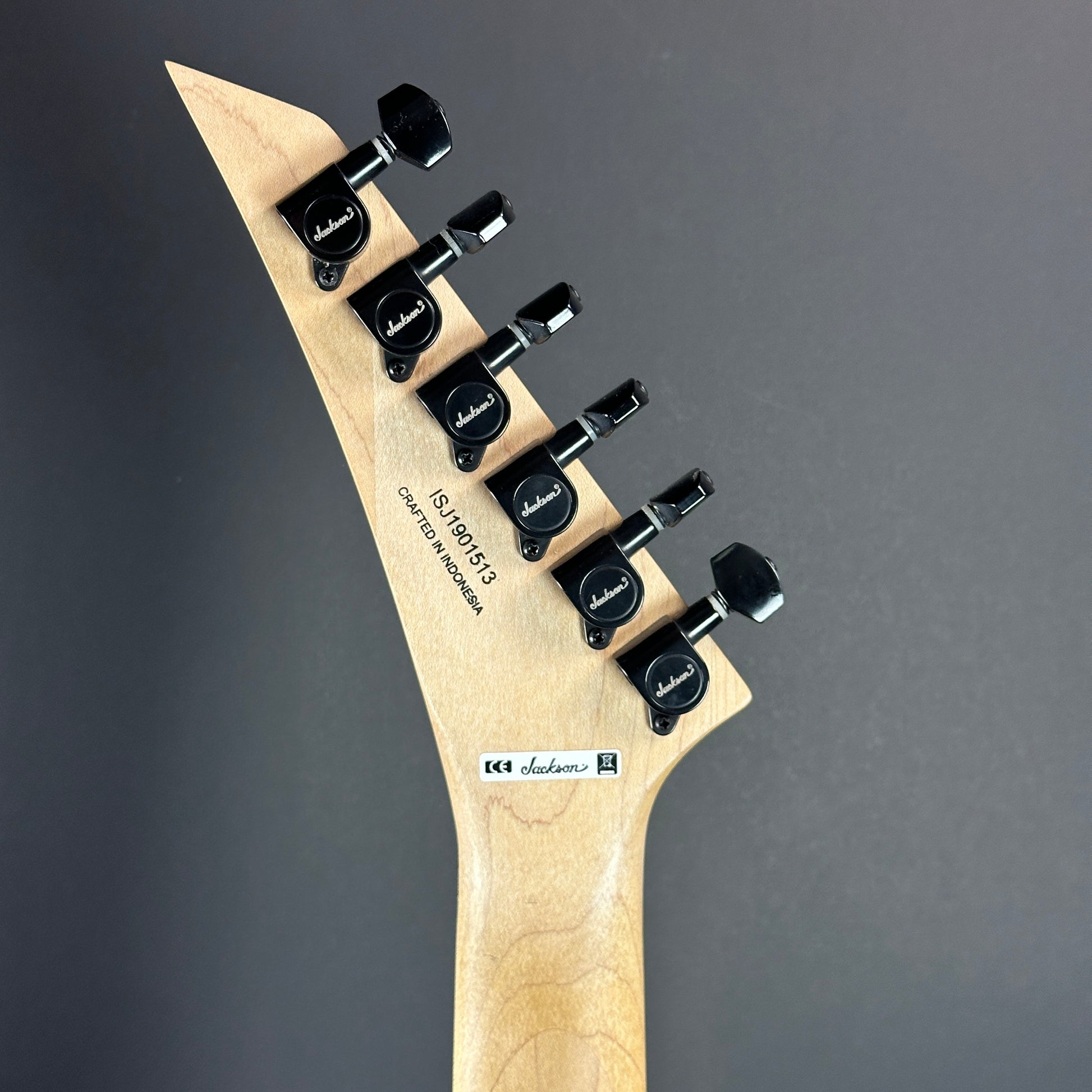 Back of headstock of Used Jackson Pro Series Soloist SL3 Satin Orange Blaze.