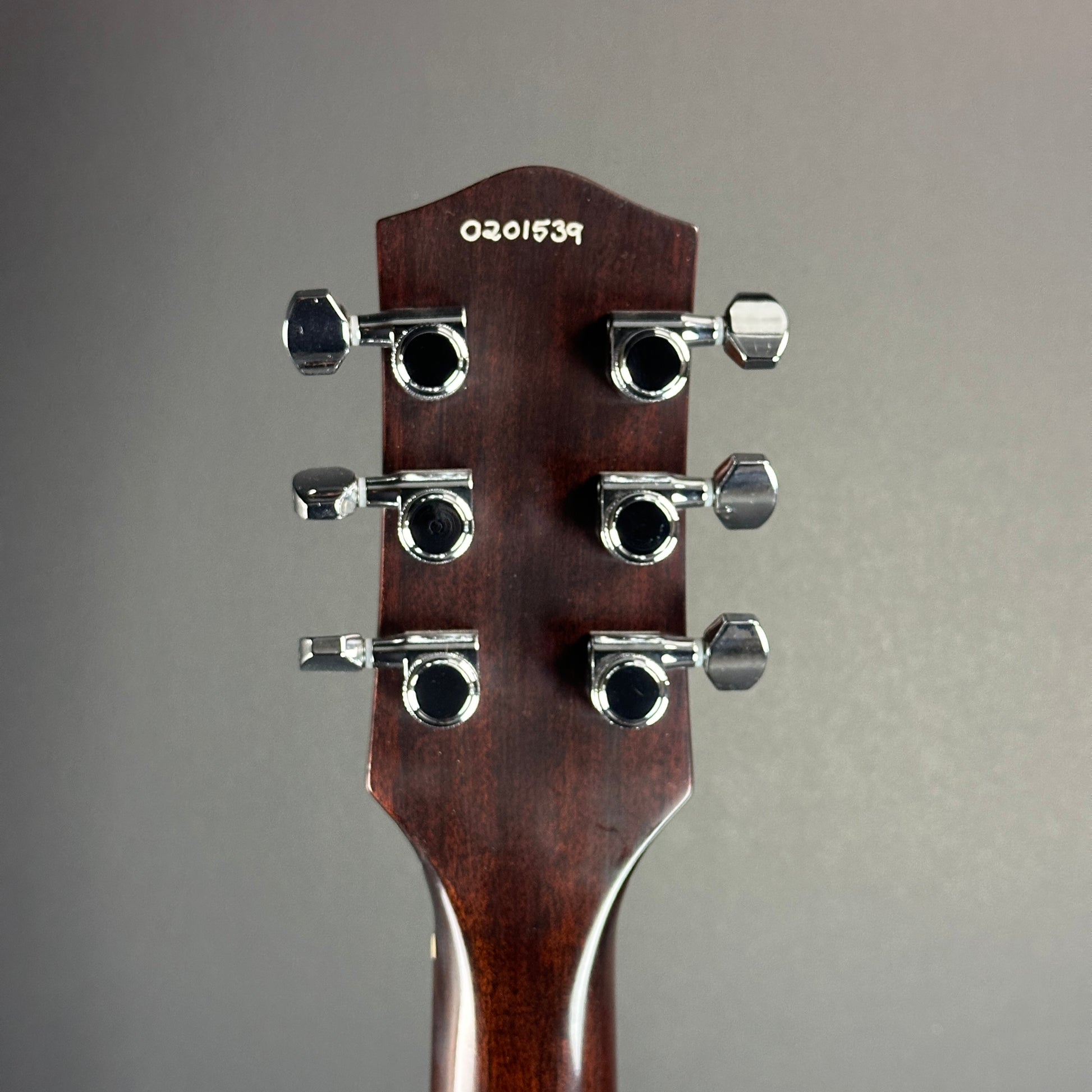 Back of headstock of Used Harmony Juno Transparent Brown Flame Maple.