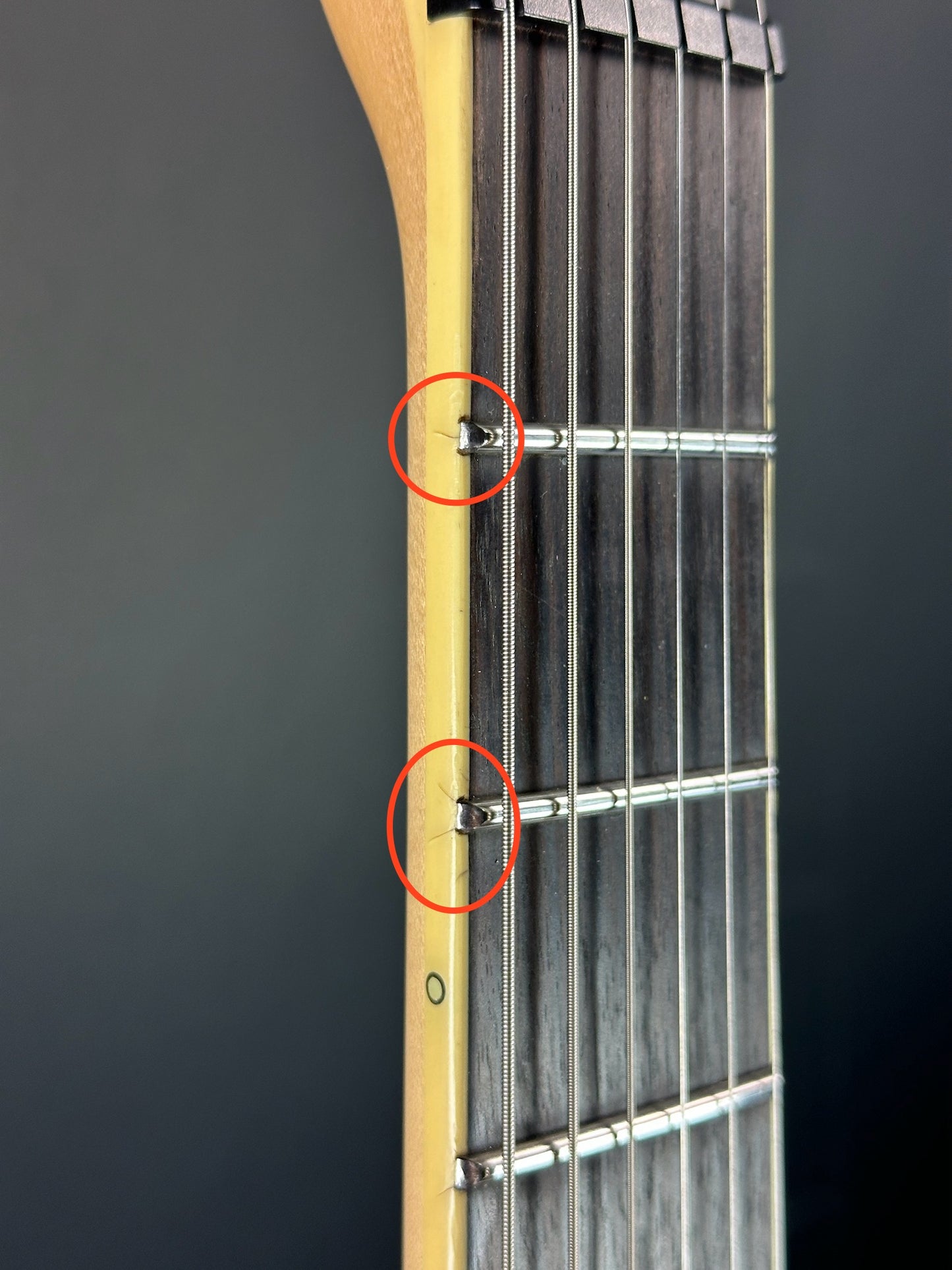 Surface cracks in binding of Used Schecter C-1 Apocalypse Carbon Black.