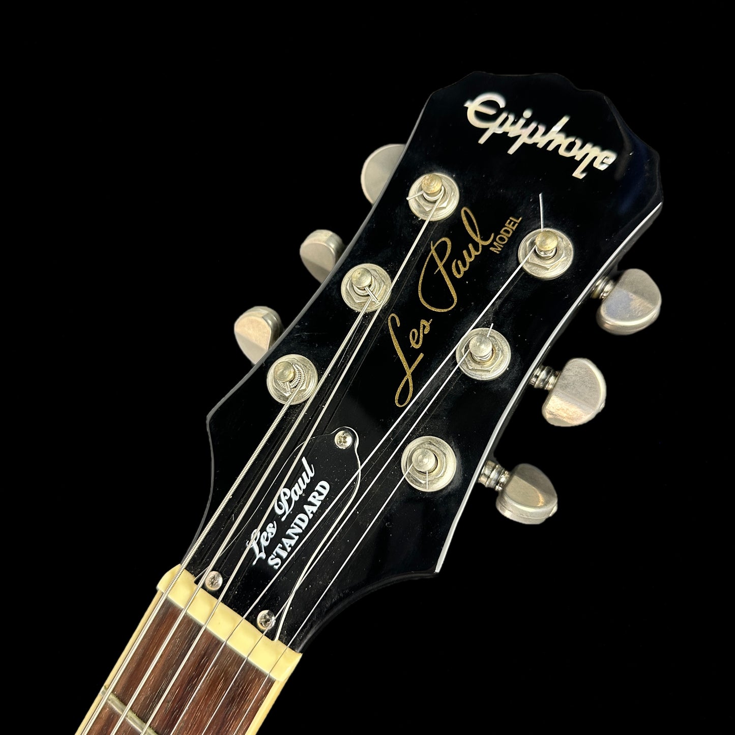 Front of headstock of Used Epiphone Les Paul Standard Ebony.