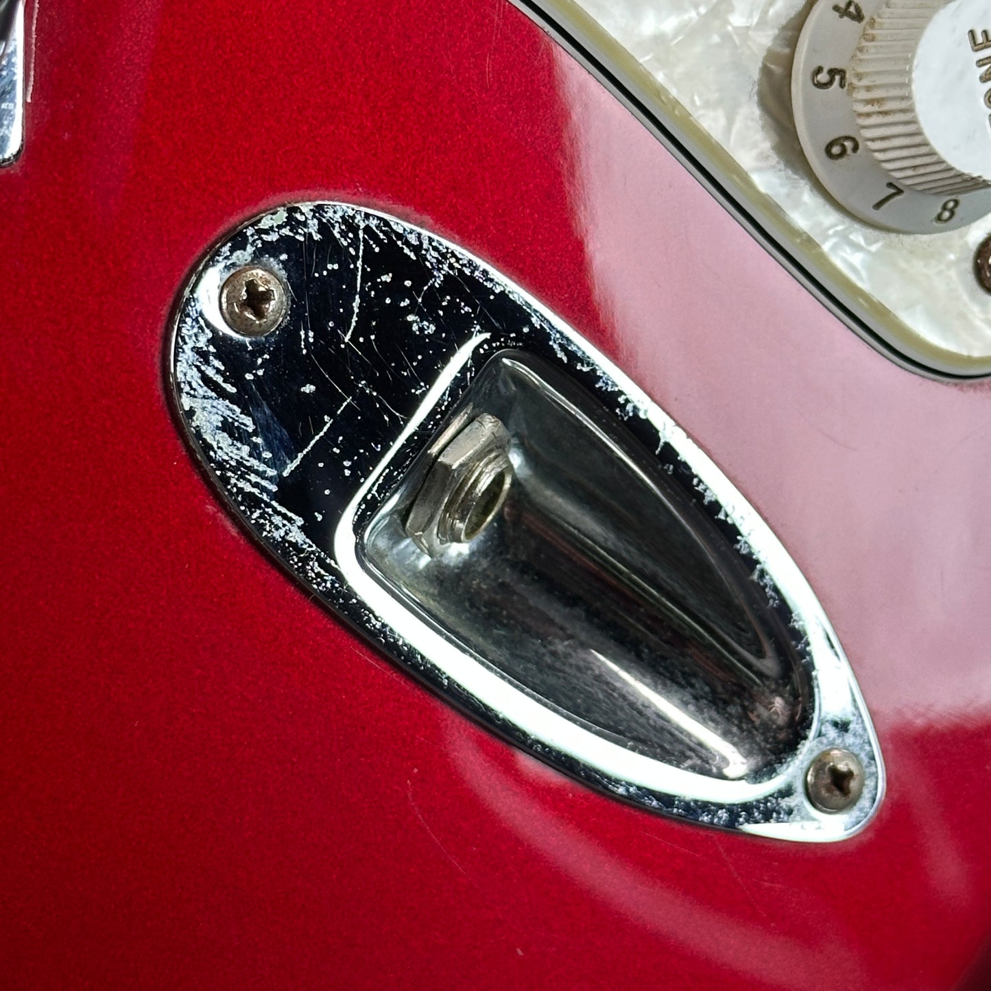 Wear on output jack of Used 2006 Fender Sam Ash 48th Street Red Strat.