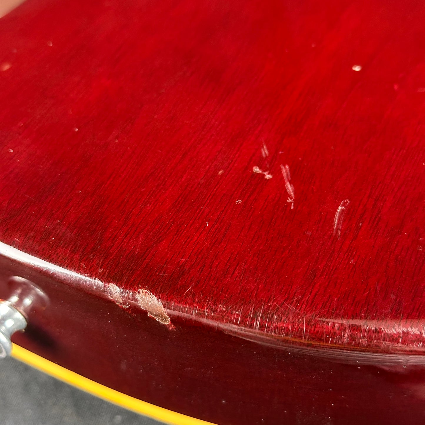 Damage near bottom strap button of Vintage 1977 Gibson Les Paul Standard Wine Red.