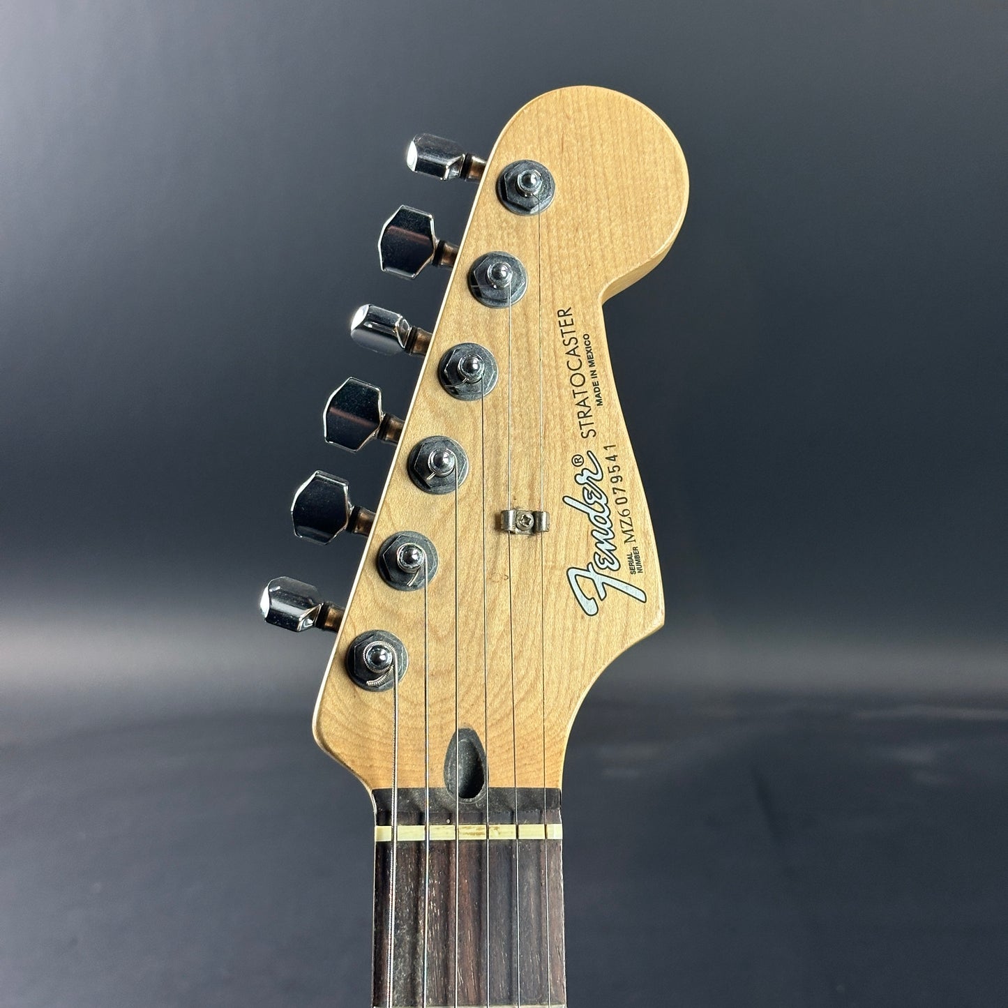 Front of headstock of Used 2006 Fender Sam Ash 48th Street Red Strat.