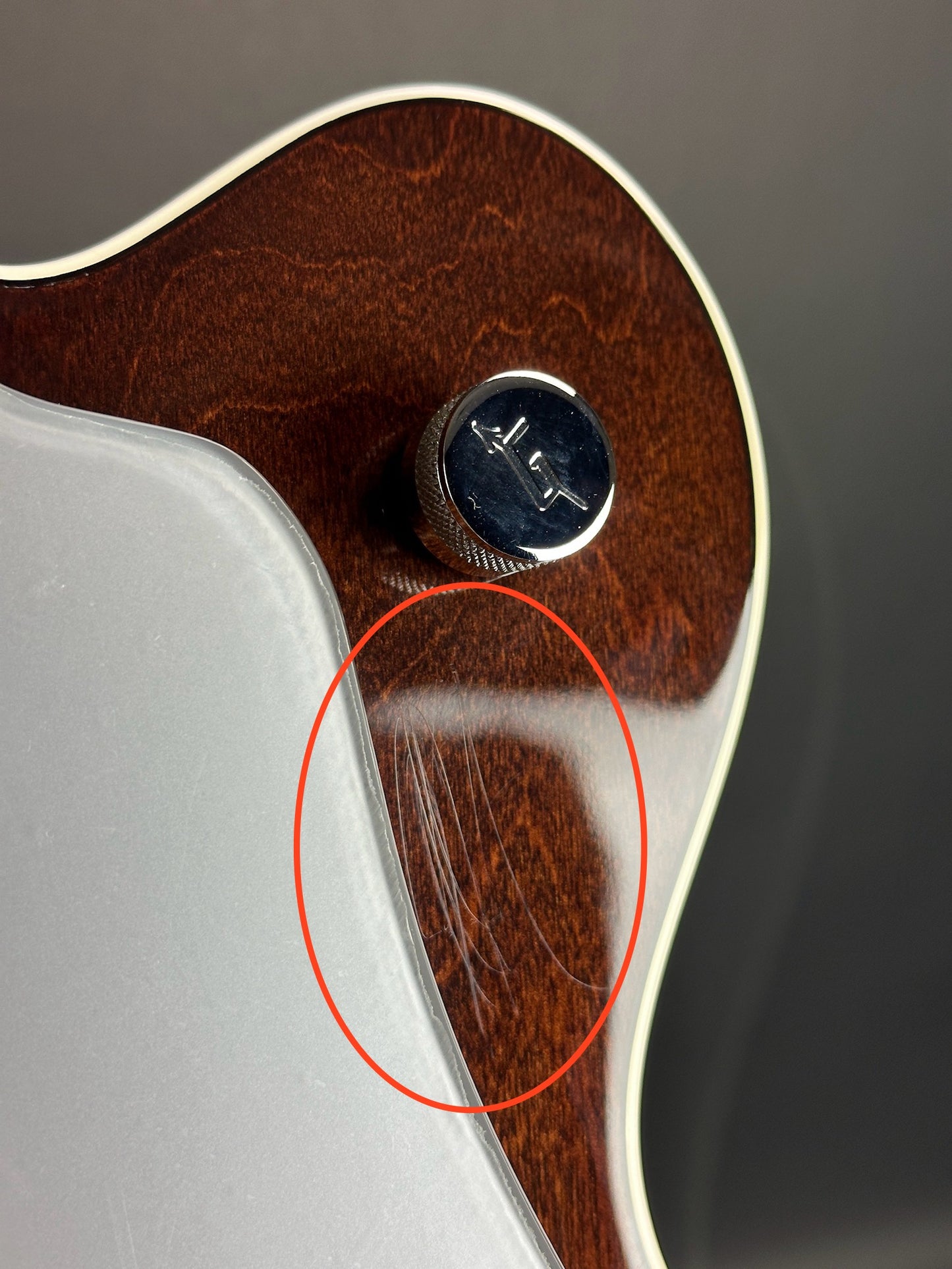 Scratches on front of Used Gretsch G6119B Walnut Broadcaster Bass.