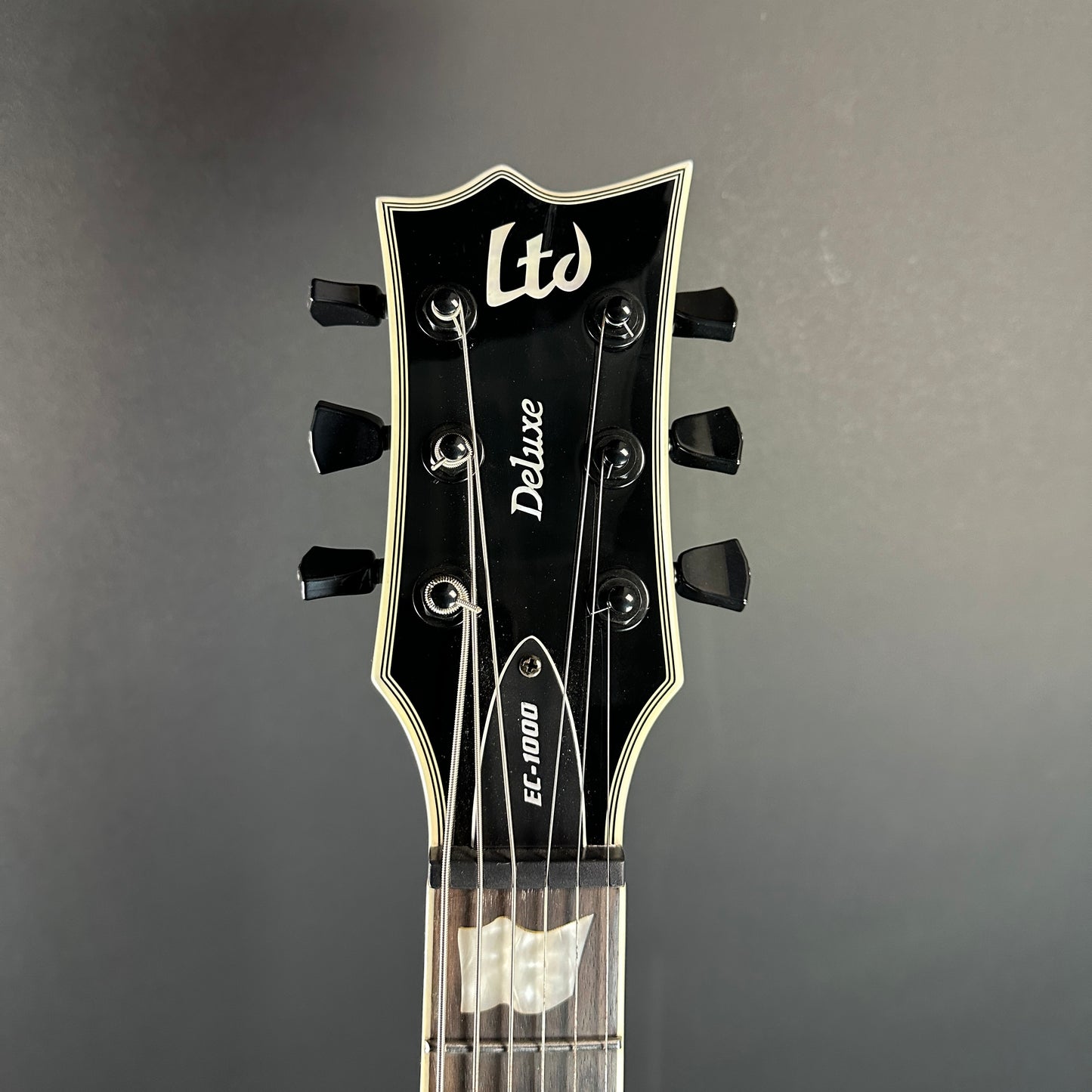 Front of headstock of Used ESP DLX EC1000 Black.