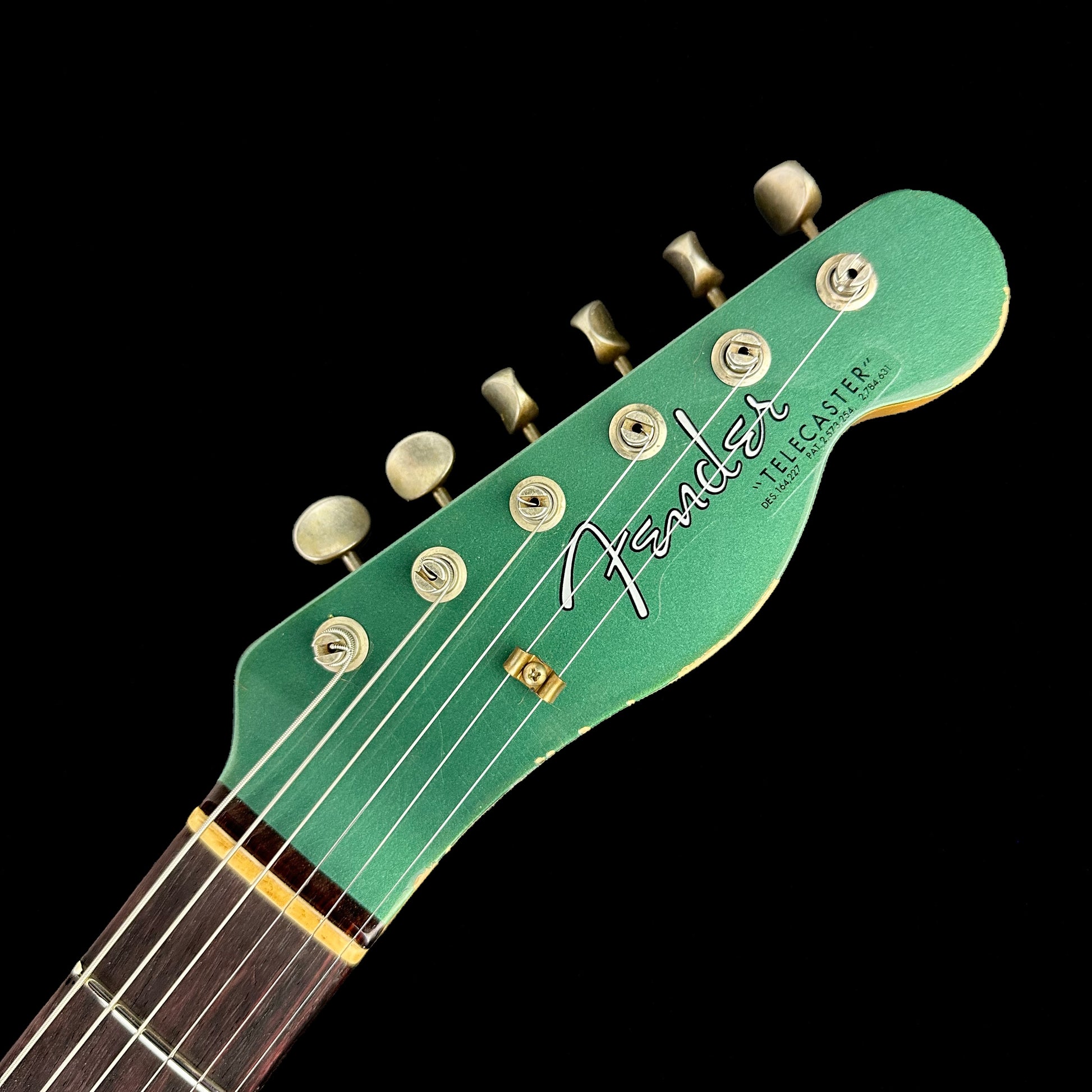 Headstock of Fender Custom Shop Limited Edition '64 Tele Relic Aged Sherwood Green Metallic.