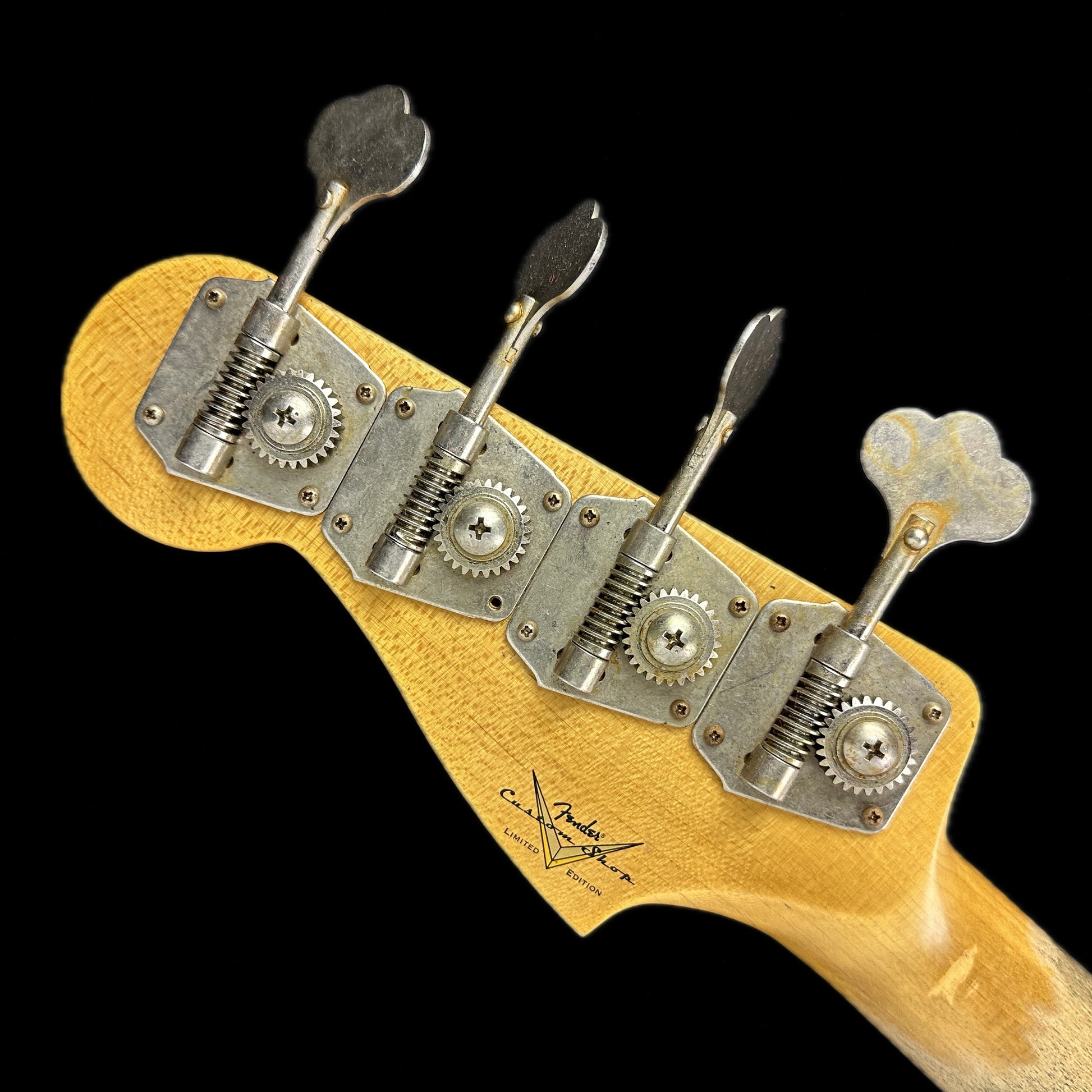 Back of headstock of Fender Custom Shop Limited Edition '59 Precision Bass Journeyman Relic Chocolate 3 Color Sunburst.