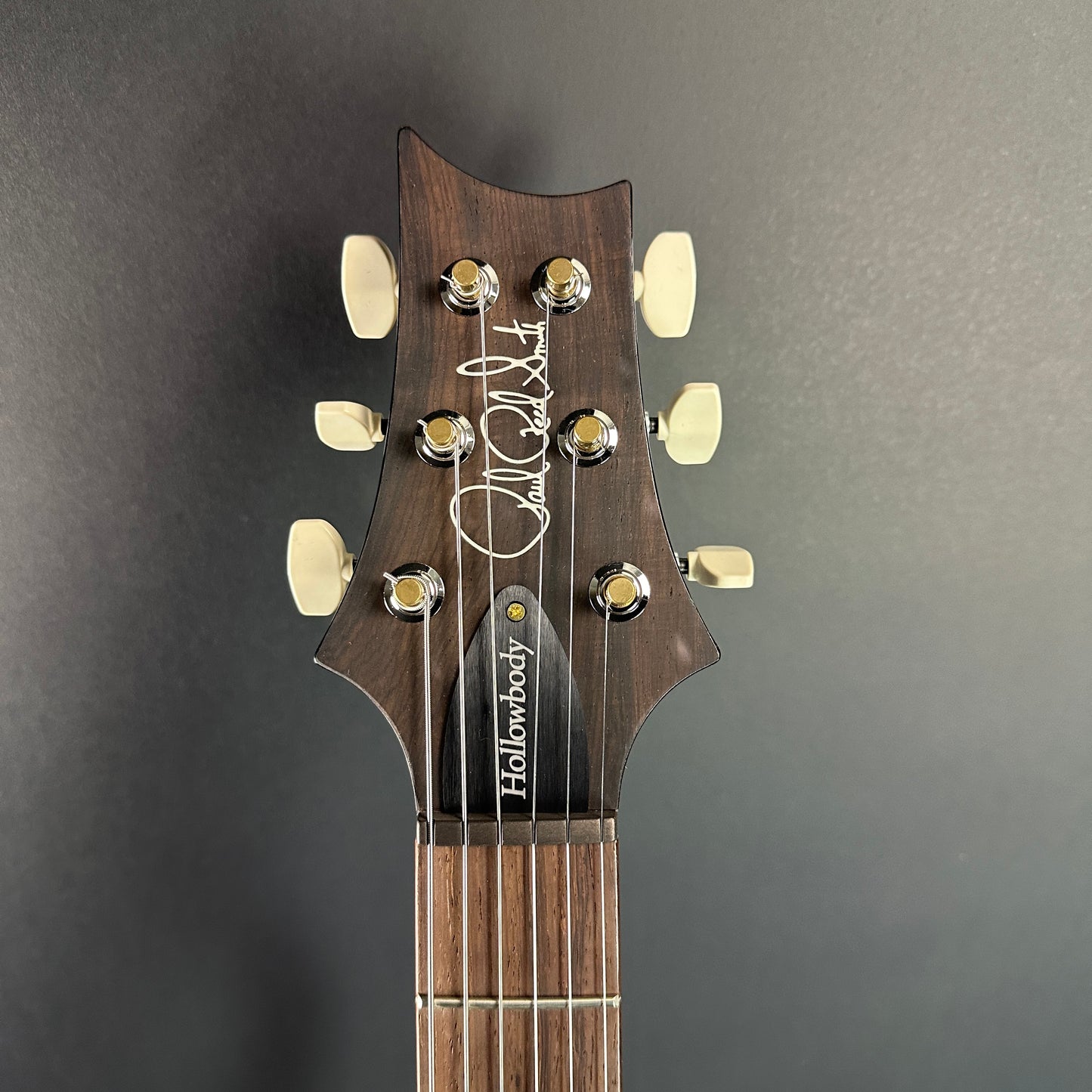 Front of headstock of PRS Wood Library Hollowbody II Piezo 10-top Eriza Verde Smokeburst.