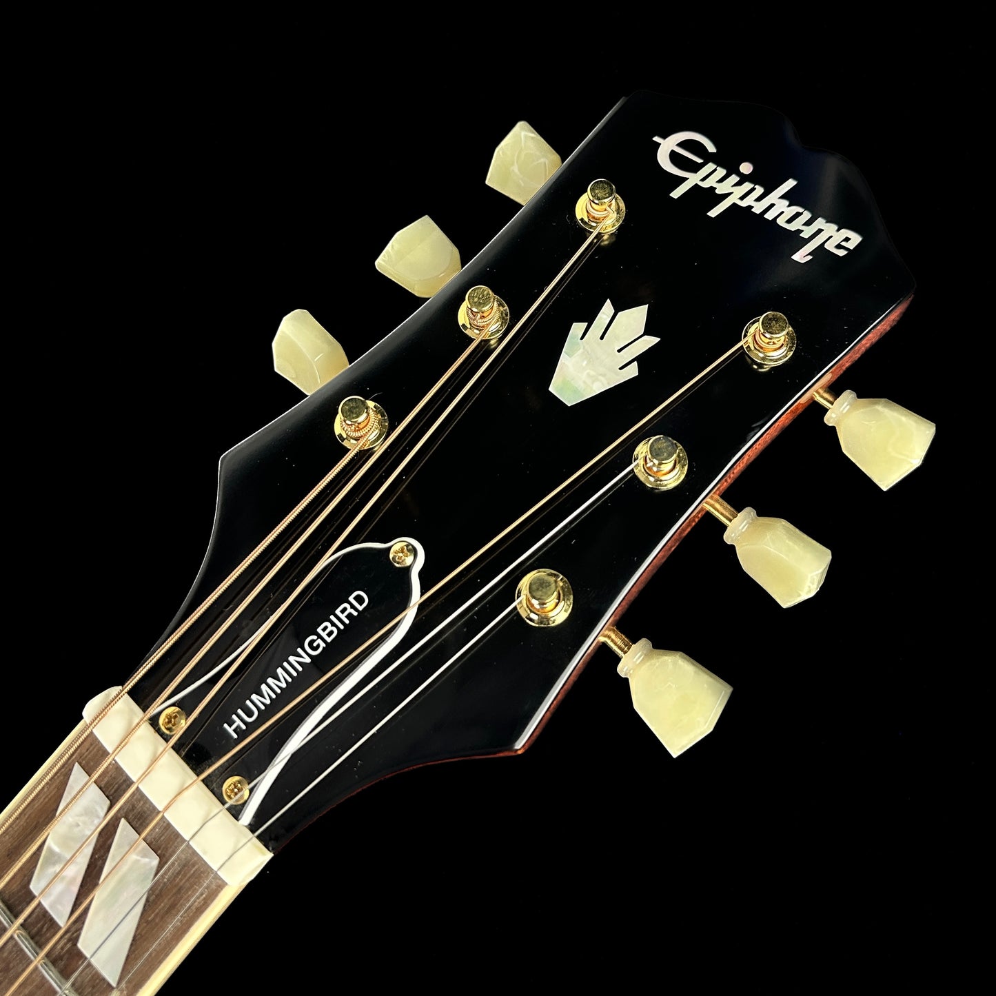 Front of headstock of Used Epiphone Hummingbird Cherry Burst AE.