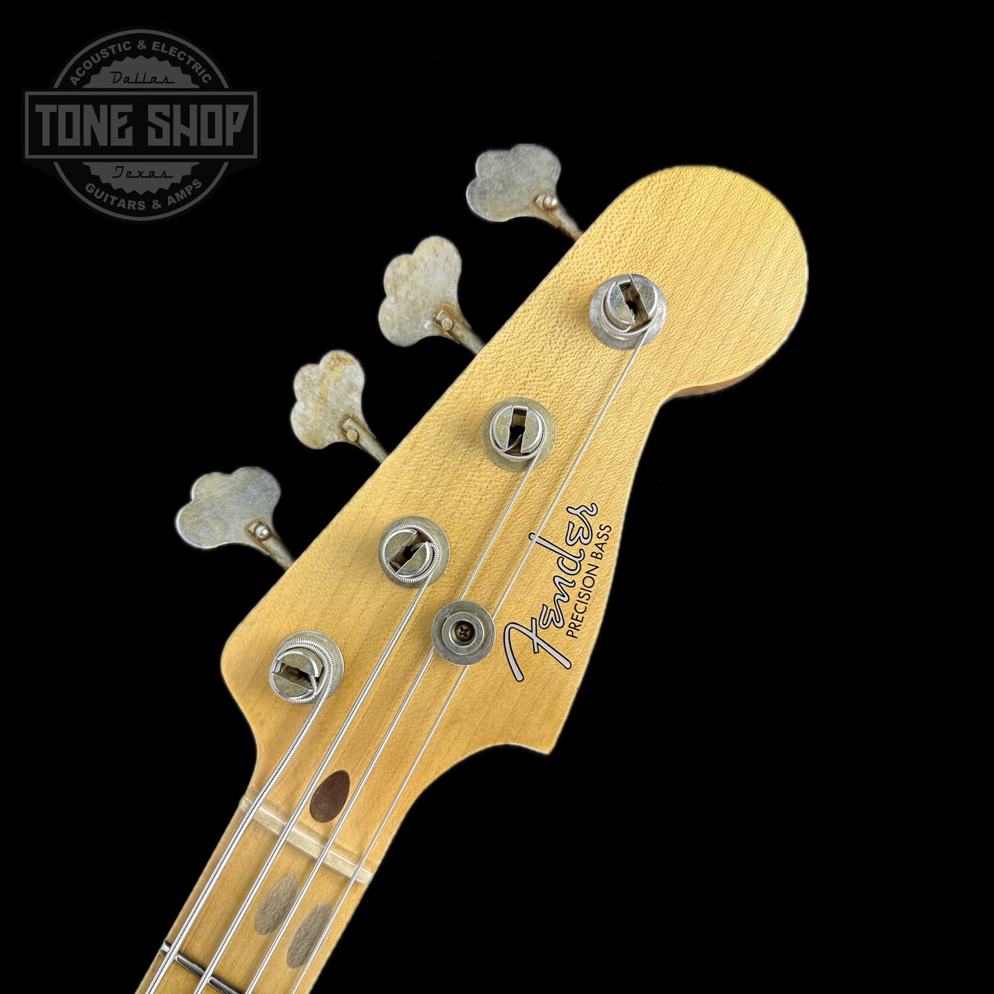 Front of headstock of Fender Custom Shop Time Machine '58 Precision Bass Relic Super Faded Aged Chocolate 3 Color Sunburst.