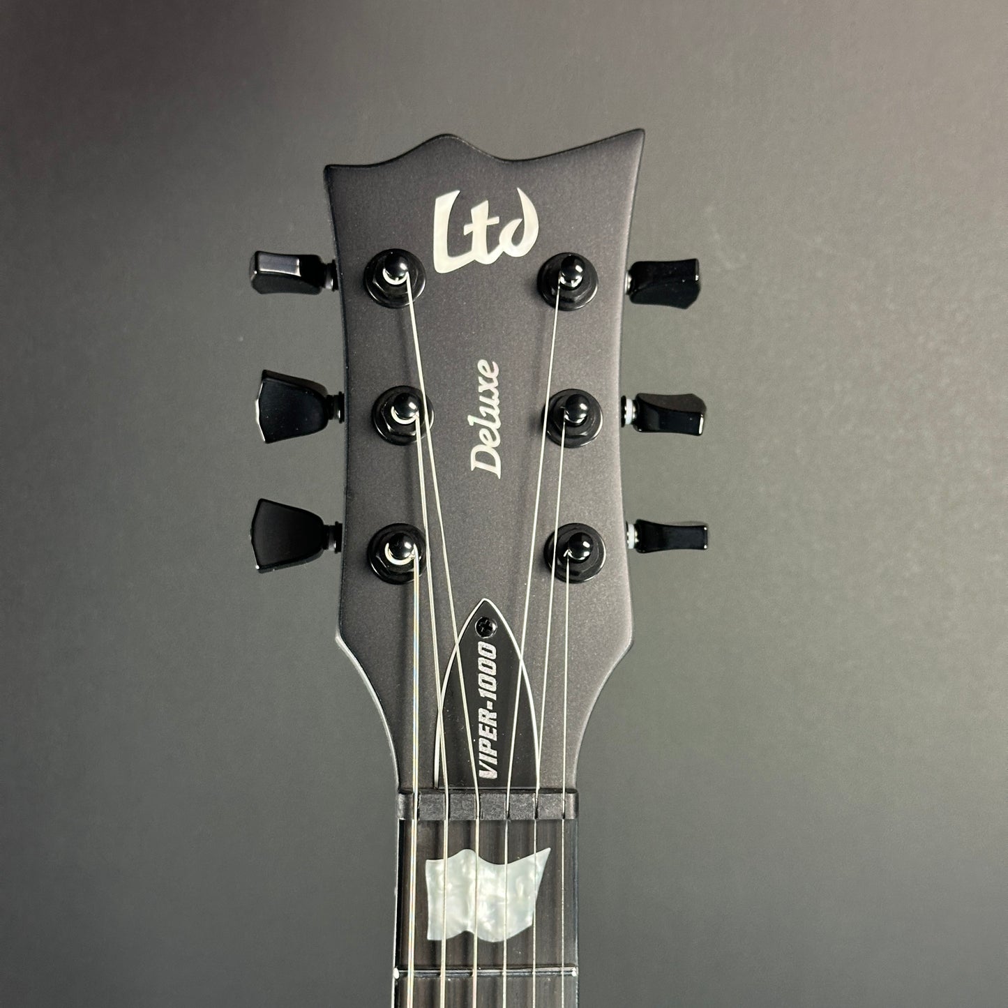 Front of headstock of Used ESP LTD Viper 1000 Deluxe Satin Black.