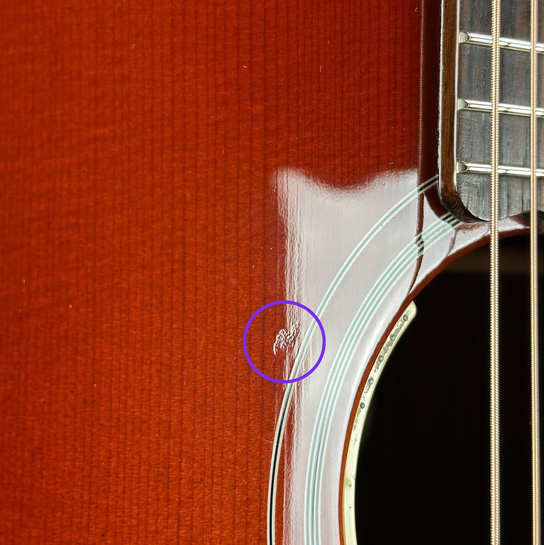 Ding near soundhole of Used Gibson SJ-200 Studio Rosewood Burst.