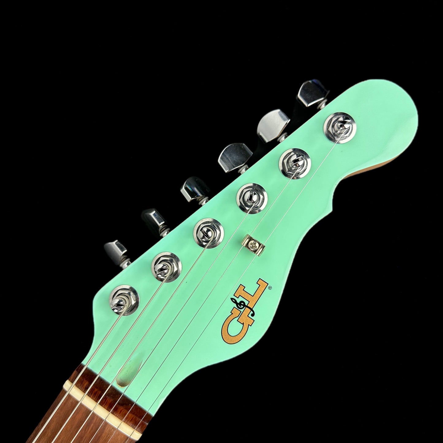 Front of headstock of Used G&L ASAT HH Surf Green P90.