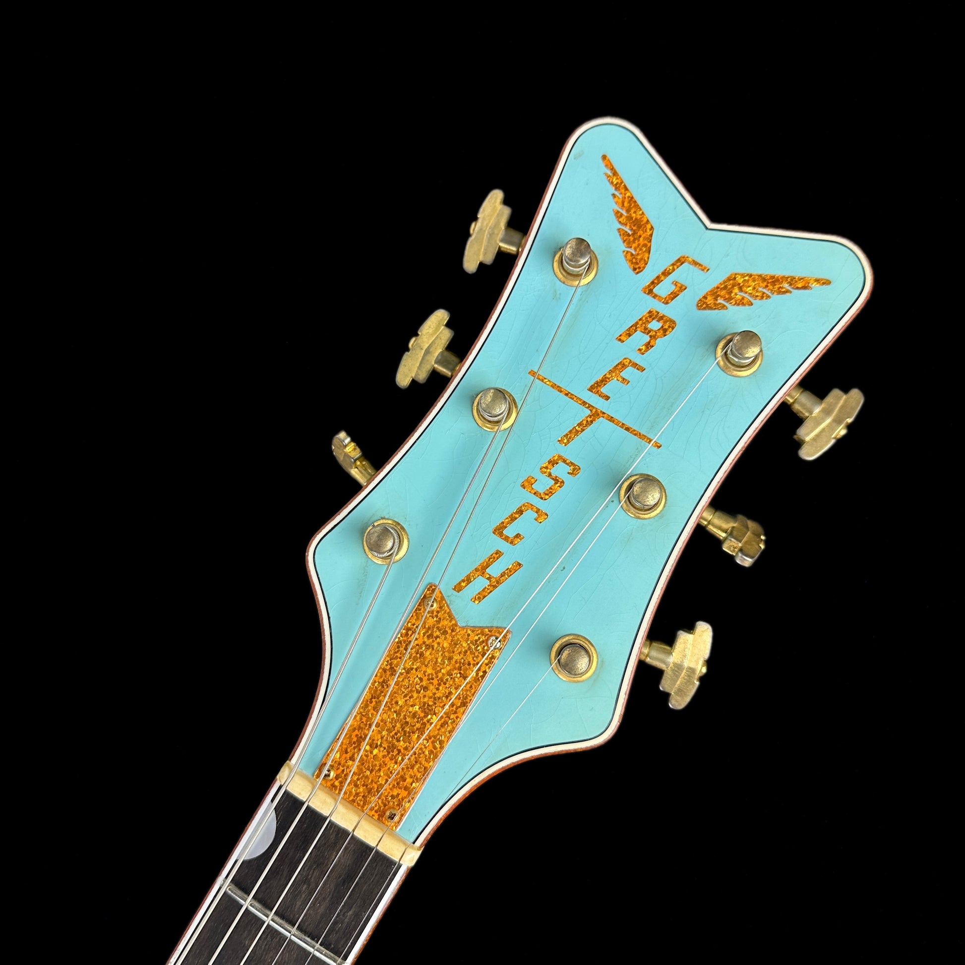 Front of headstock of Gretsch Custom Shop G6134-59 Penguin Relic Daphne Blue.