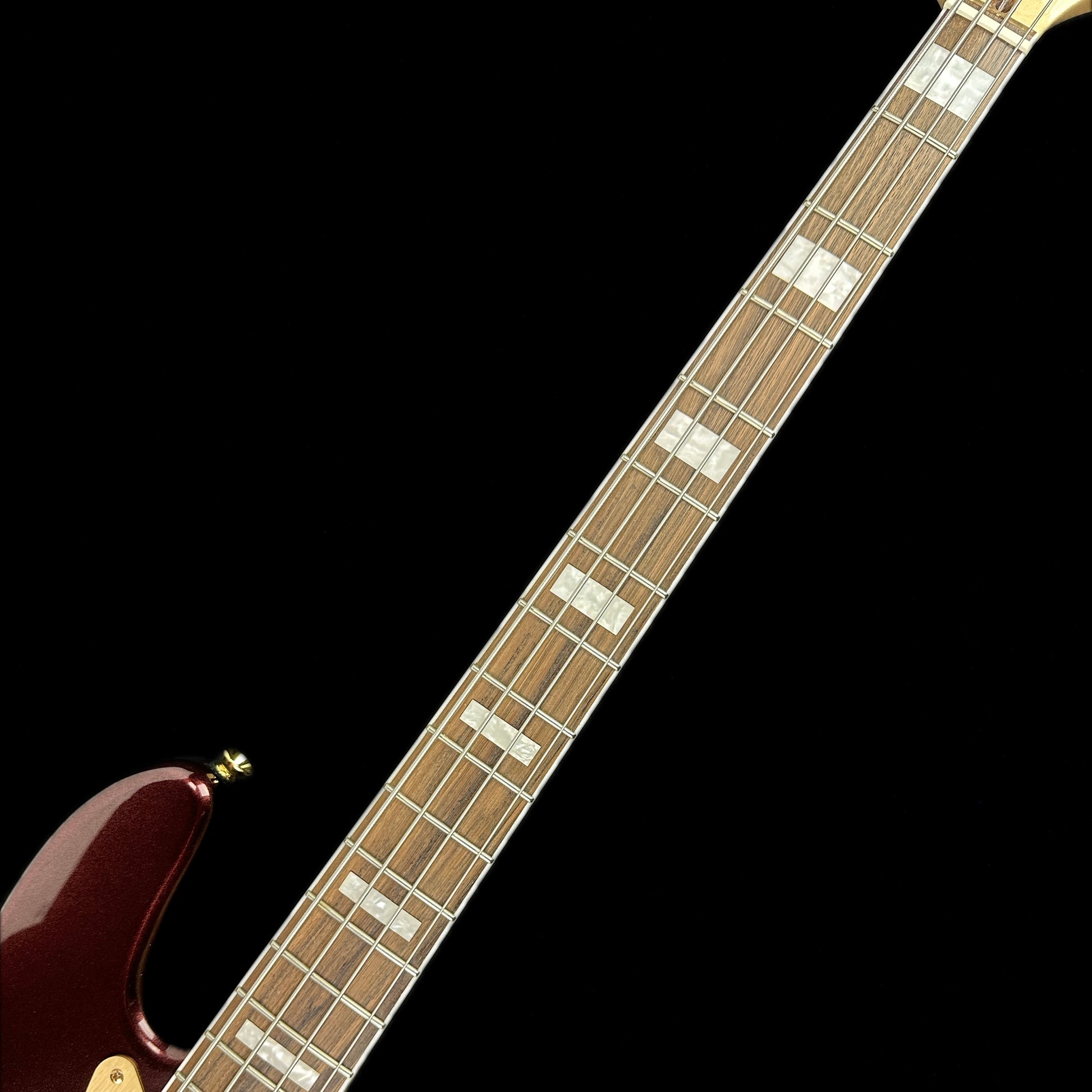 Fretboard of Used Squier 40th Anniversary Jazz Bass Ruby Red Metallic.