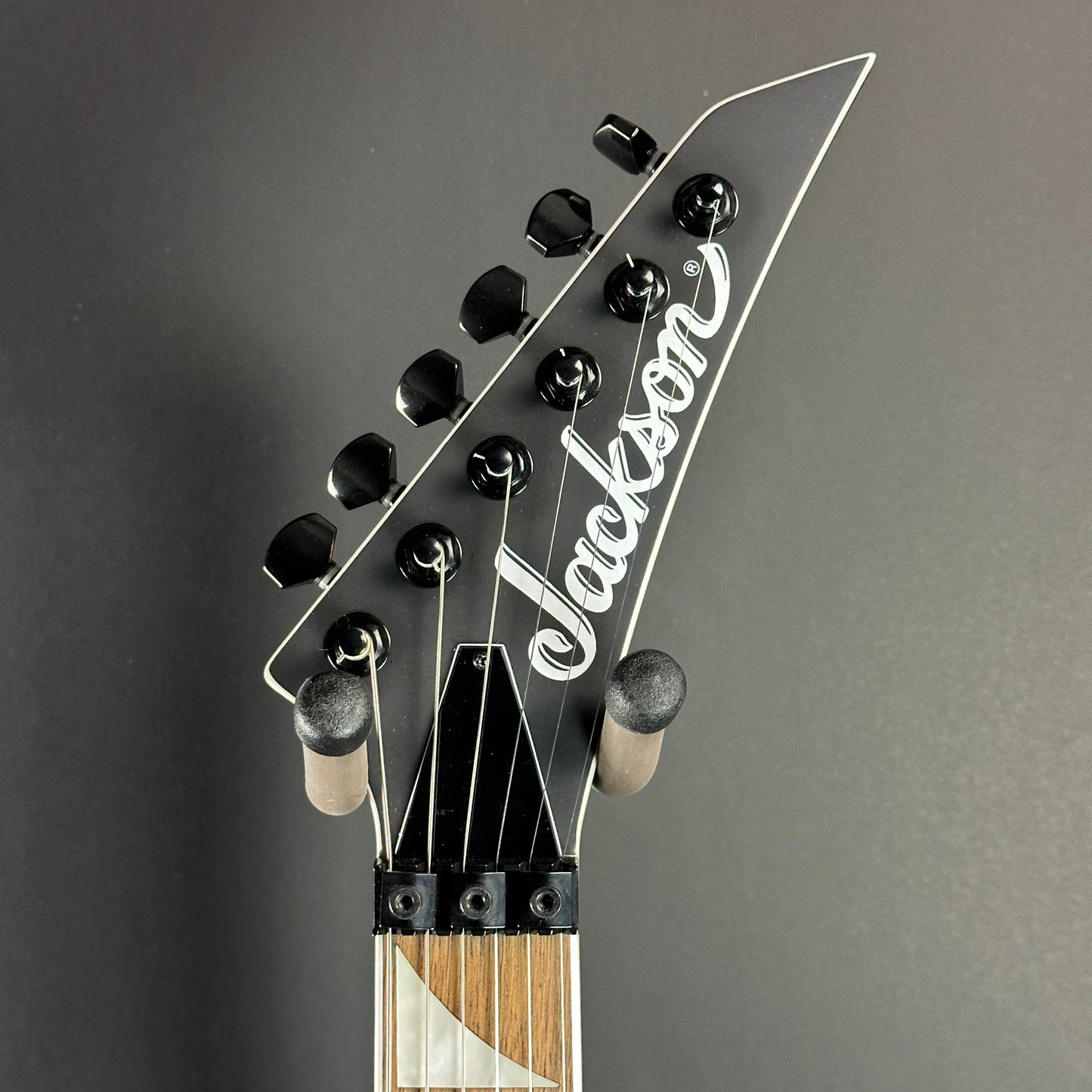 Front of headstock of Used Jackson WRX24 Warrior Black.