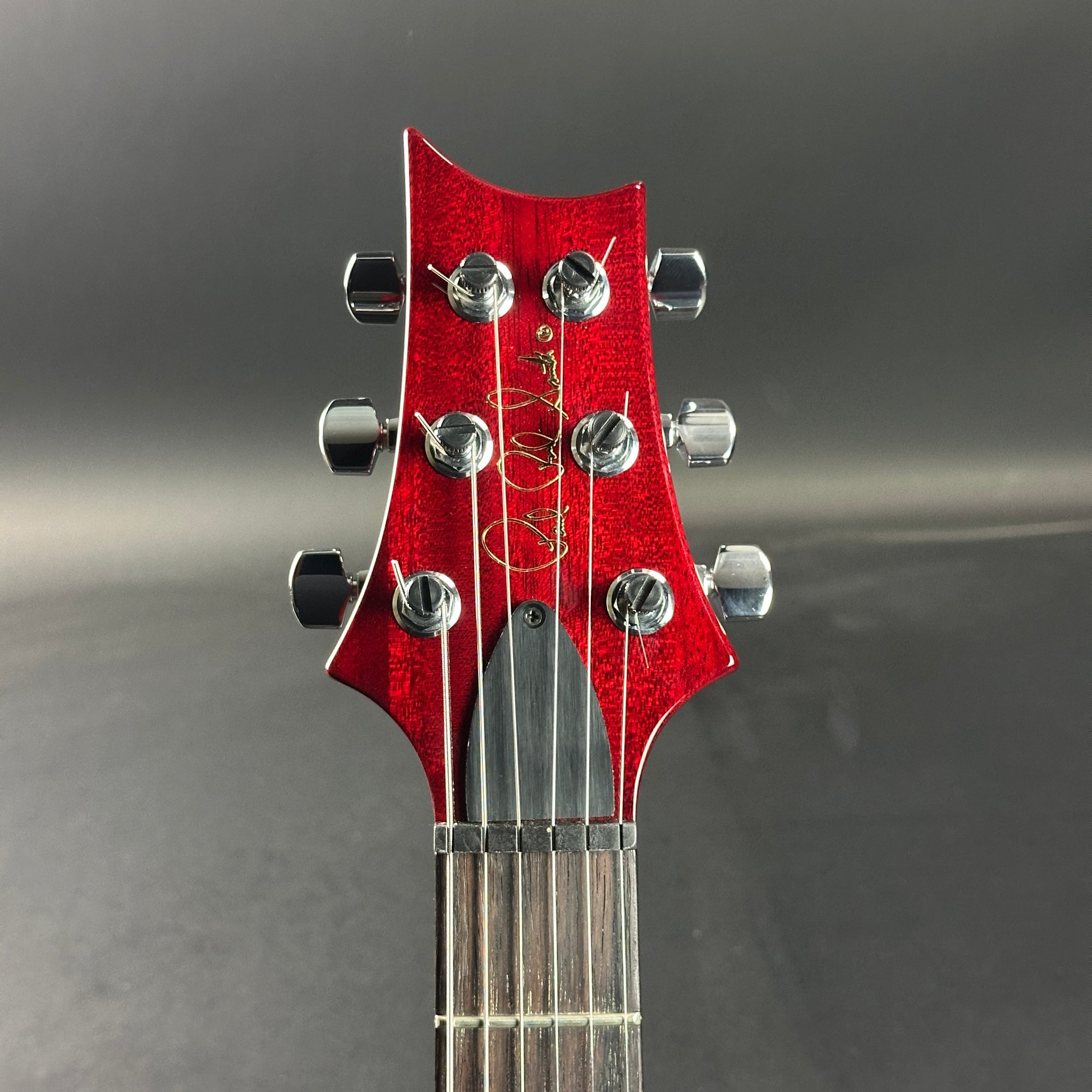 Front of headstock of Used 2006 PRS Custom 24 10 Top Ruby Red.