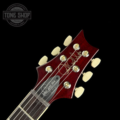 Front of headstock of PRS S2 McCarty 594 2024 Spec TSG Flame Top Dark Cherry Sunburst.