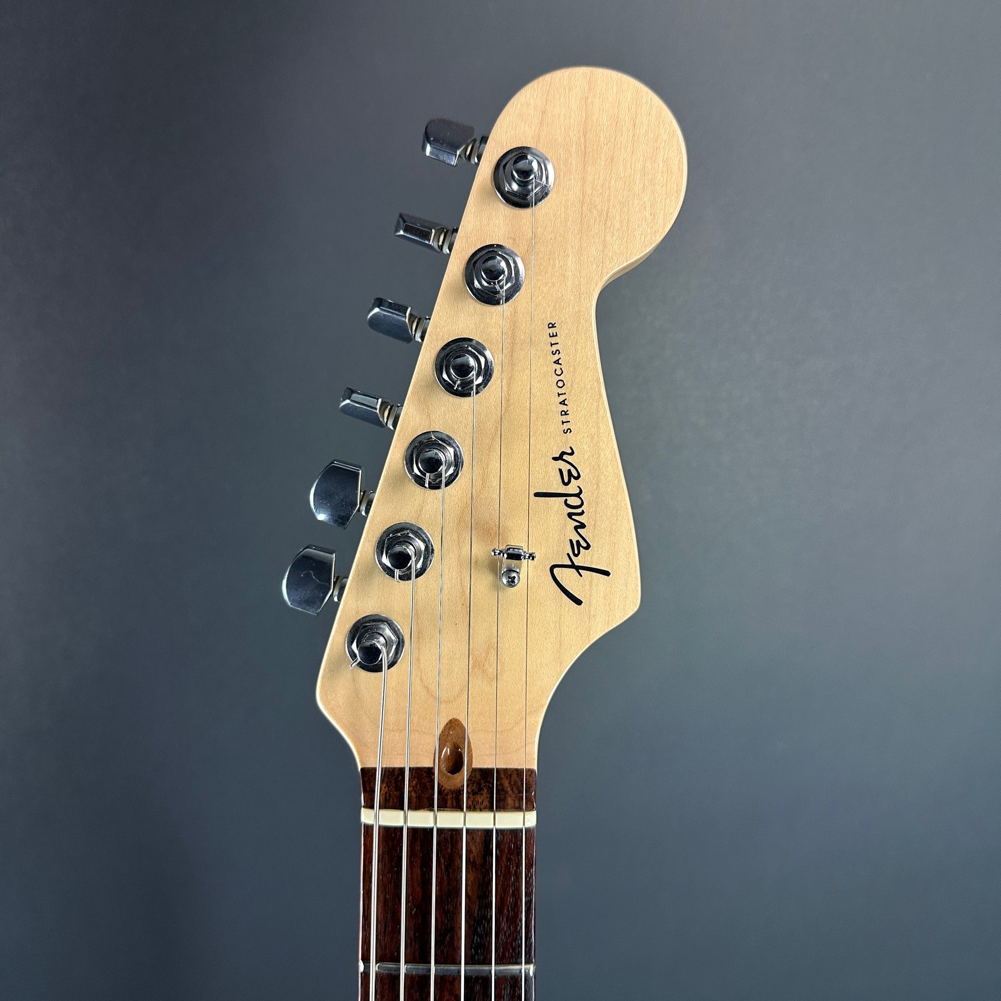 Front of headstock of Used Fender American Deluxe Strat Burst.