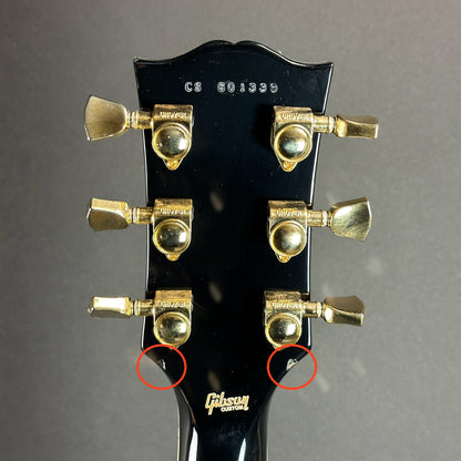 Two marks on back of headstock of Used Gibson Les Paul Custom Ebony.