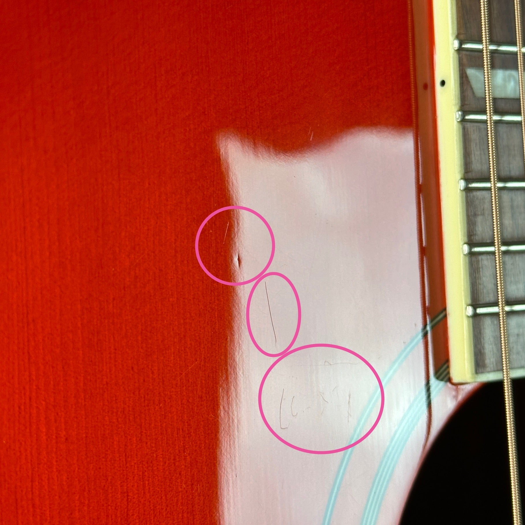 Scratches near soundhole of Used Epiphone Hummingbird Studio AE Cherry Burst.