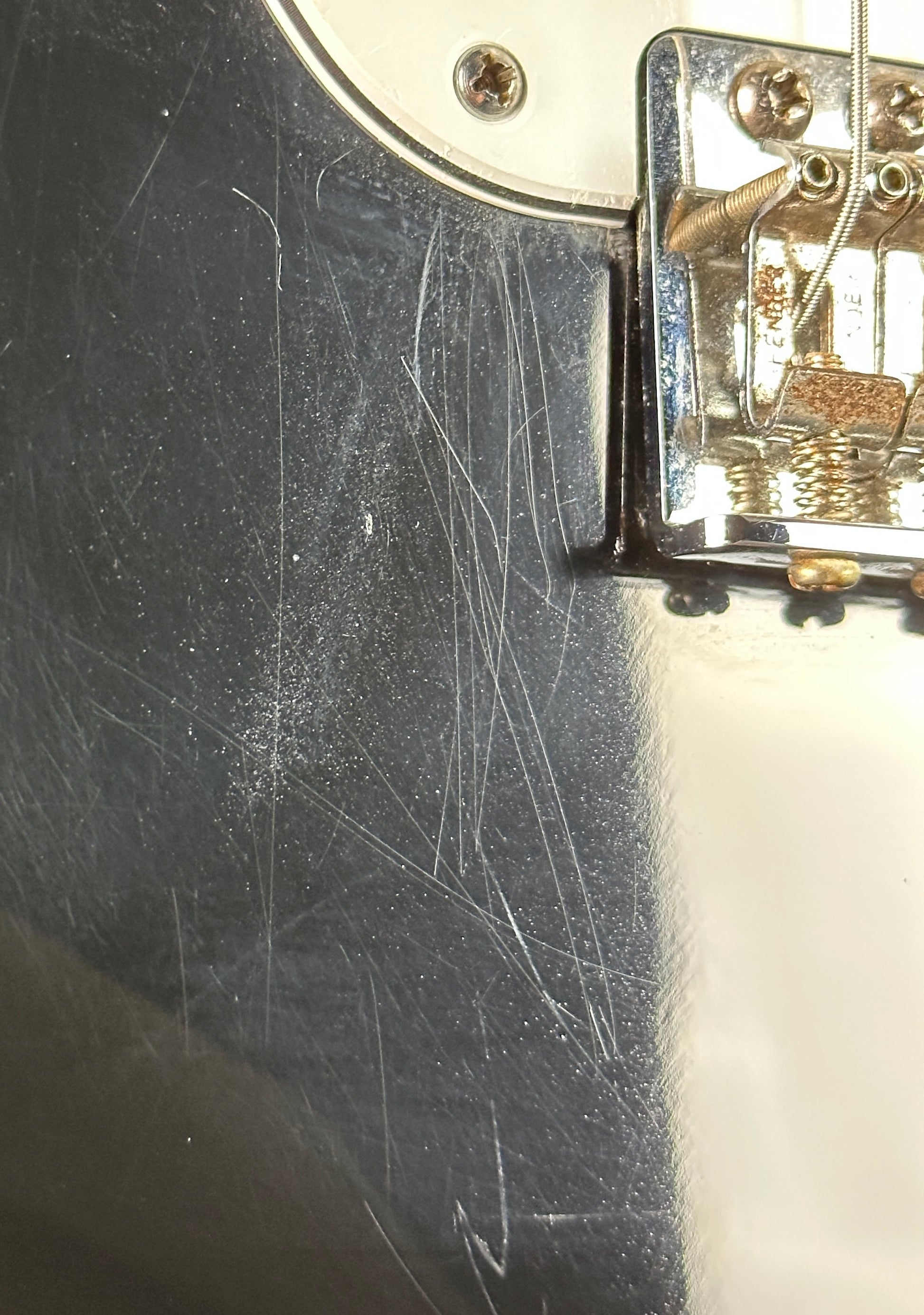 Scratches on body of Used Fender MIM Standard Strat Black.