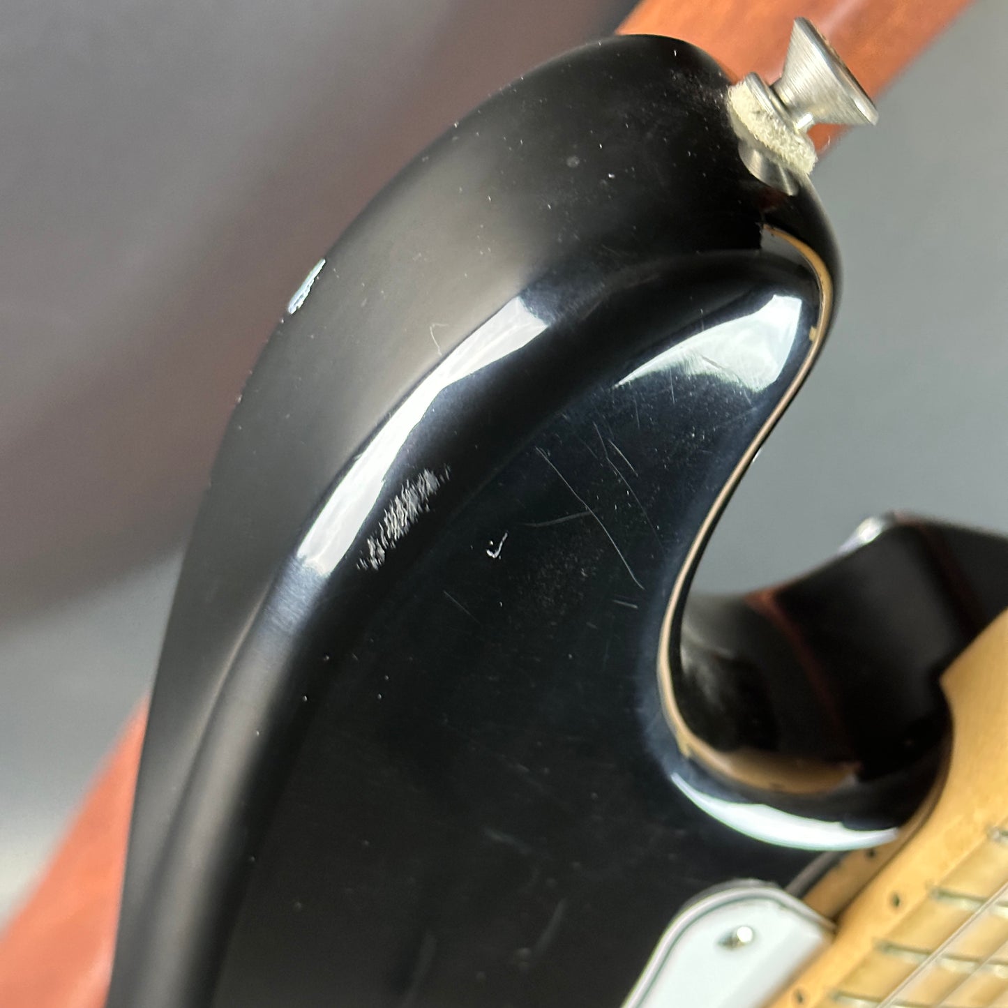 Scratches on upper horn of Used Fender MIM Standard Strat Black.