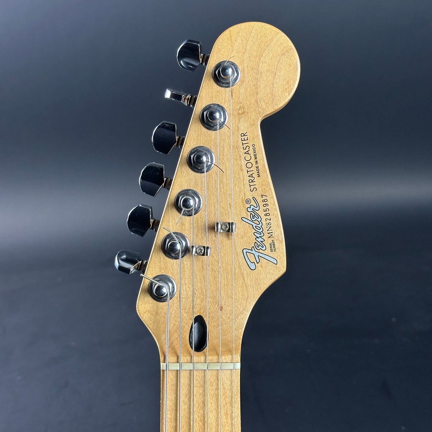 Headstock of Used Fender MIM Standard Strat Black.